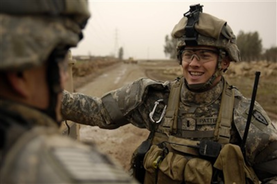 1st Lt. Tyler Patterson, U.S. Army, talks with one of his soldiers during a visit with Sheik Alassi Burhan near Riyahd, Iraq, on Feb. 6, 2007.  Patterson is assigned to Delta Company, 2nd Battalion, 27th Infantry Regiment, 3rd Brigade Combat Team, 25th Infantry Division.  