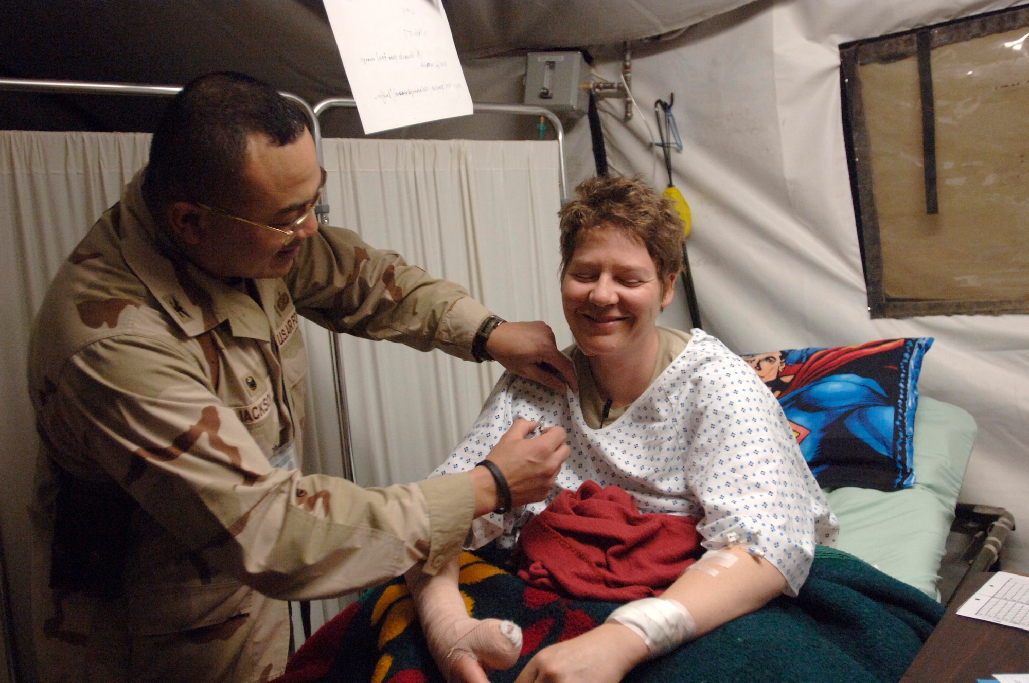 BALAD AIR BASE, Iraq -- Staff Sgt. Kathryn Robinson receives her Purple Heart medal from Col. Lawrence Jackson II, 732nd Expeditionary Mission Support Group commander, for wounds received from small arms fire.  Sergeant Robinson was on a cordon and search rescue mission with the military transition teams and Iraqi Army near Baqubah when she was struck by a sniper's bullet in the left forearm and the upper right thumb Feb. 10.  Sergeant Robinson is assigned to the 4th Combat Camera Squadron, March Air Reserve Base, Calif.  (US Air Force photo/Tech. Sgt. Cecilio M. Ricardo Jr.)