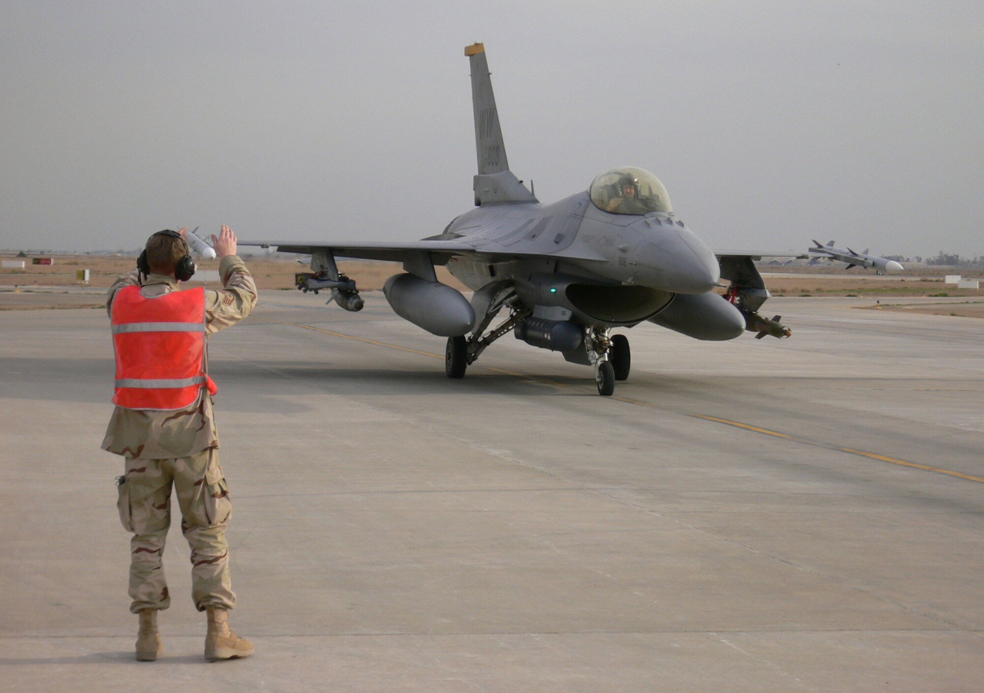 070216 -- BALAD AIR BASE, Iraq -- A Misawa Airman marshals in a 14th Expeditionary Fighter Squadron at Balad after returning from a mission in Iraq. The 14th Fighter Squadron was the third EFS to stand up at Balad when the Misawa squadron deployed there in January. (Courtesty photo)