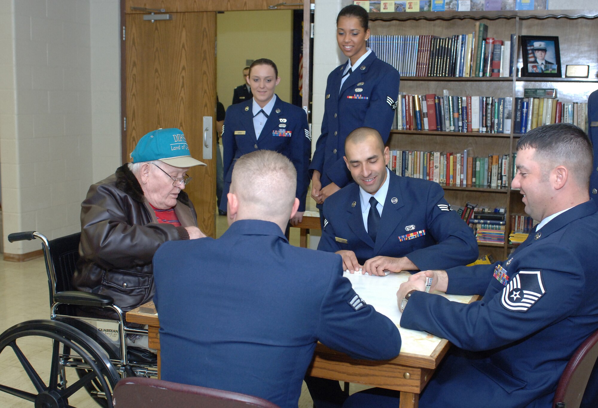 Altus Air Force Base, Okla. Airmen tried in vain to beat the Clinton, Okla., State Veterans Center resident dominoes player, Robert Morrison, Feb. 14. More than 60 Airmen from Altus AFB visited the VA Center, bringing hand-made valentines from Altus school children for the veterans and spent time with the residents, listening to stories from those who had gone before.