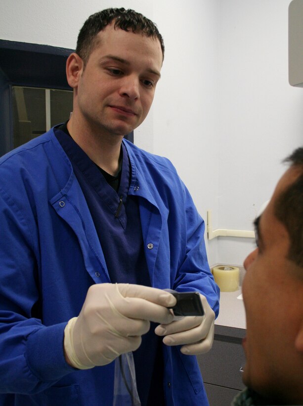 Staff Sgt. Christopher Shaw, the noncommsioned officer in charge of dental radiology, demonstrates how to use the new digital radiography equipment Feb. 15 at the 82nd Dental Squadron. (U.S. Air Force photo/Adrian McCandless)