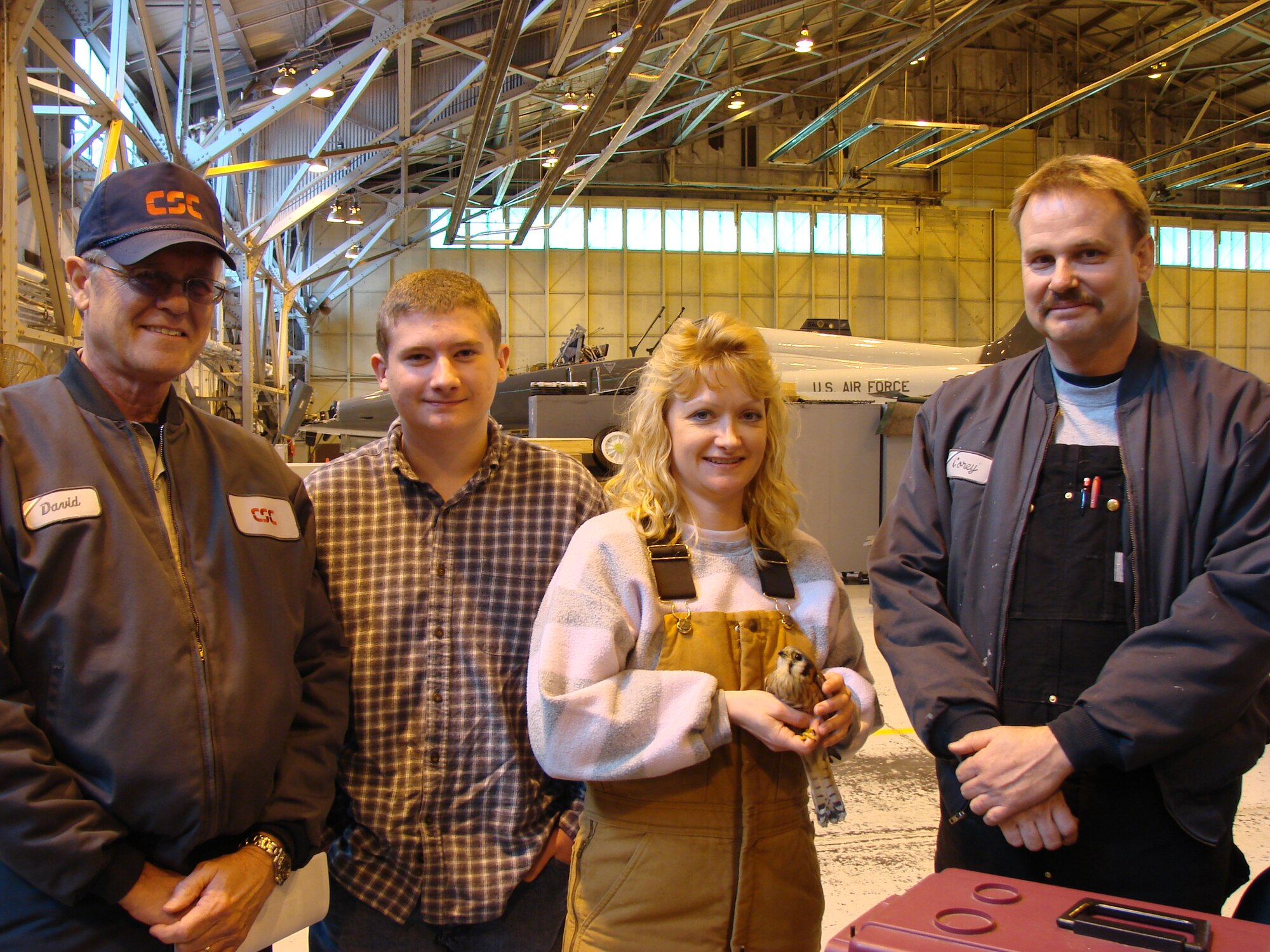 From left to right:  David Crabtree, CSC Civil Engineer, Phillip Miller, Julie Miller, Wildlife Rehabilitator, and Corey Wieden, CSC Aircraft Mechanic take one last close look before sending Buster back on her way. (Photo by 2nd Lt. Agneta Murnan) 