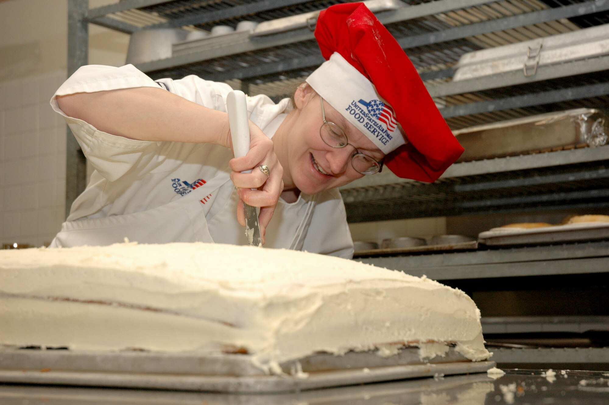 MOUNTAIN HOME AIR FORCE BASE, Idaho -- Tech. Sgt. Marlene E. Booth from the Wagon Wheel Dining Facility here frosts a cake while preparing the lunchtime meal at the facility Feb. 15. A team of Air Force food service experts visits the base Feb. 24 to rate the base’s dining facilities against others across the Air Force as part of the annual John L. Hennessy Trophy competition. Air Force photo by Airman Samantha DeVries