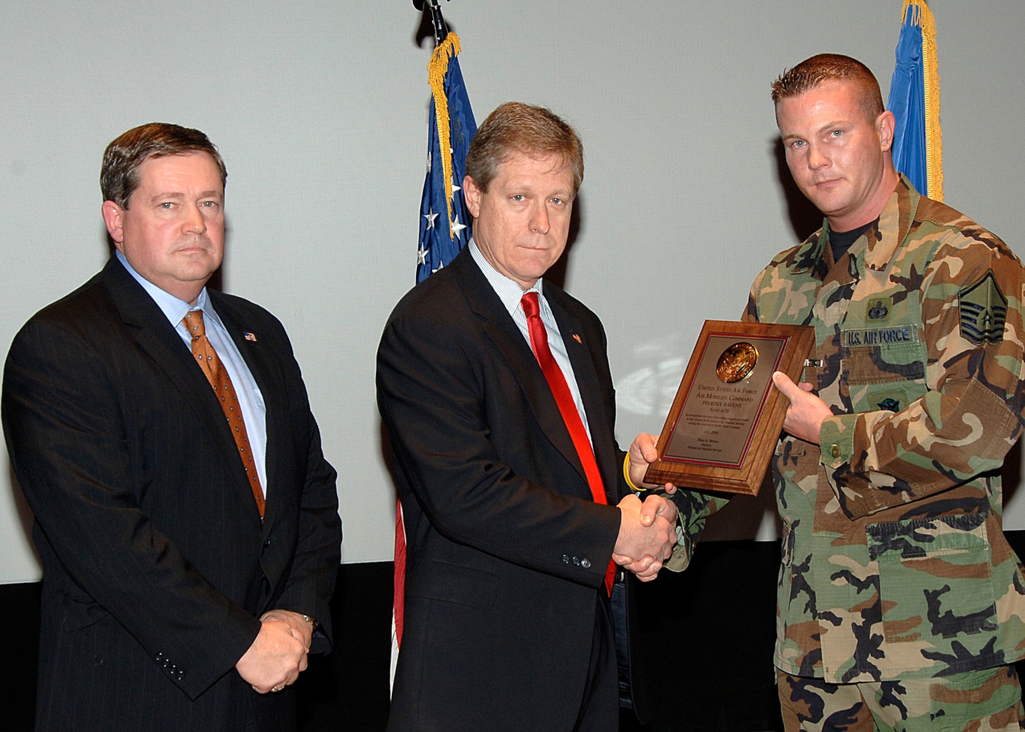From Left: FAMS representatives Richard Farwell and Howard Jordan present the FAMS Appreciation Award to Sergeant Larkin, Feb. 12.  The FAMS credit the RAVENs with the success of the evacuation of Americans from Lebanon last July. (U.S. Air Force photo by Airman Jonathan Lovelady)  