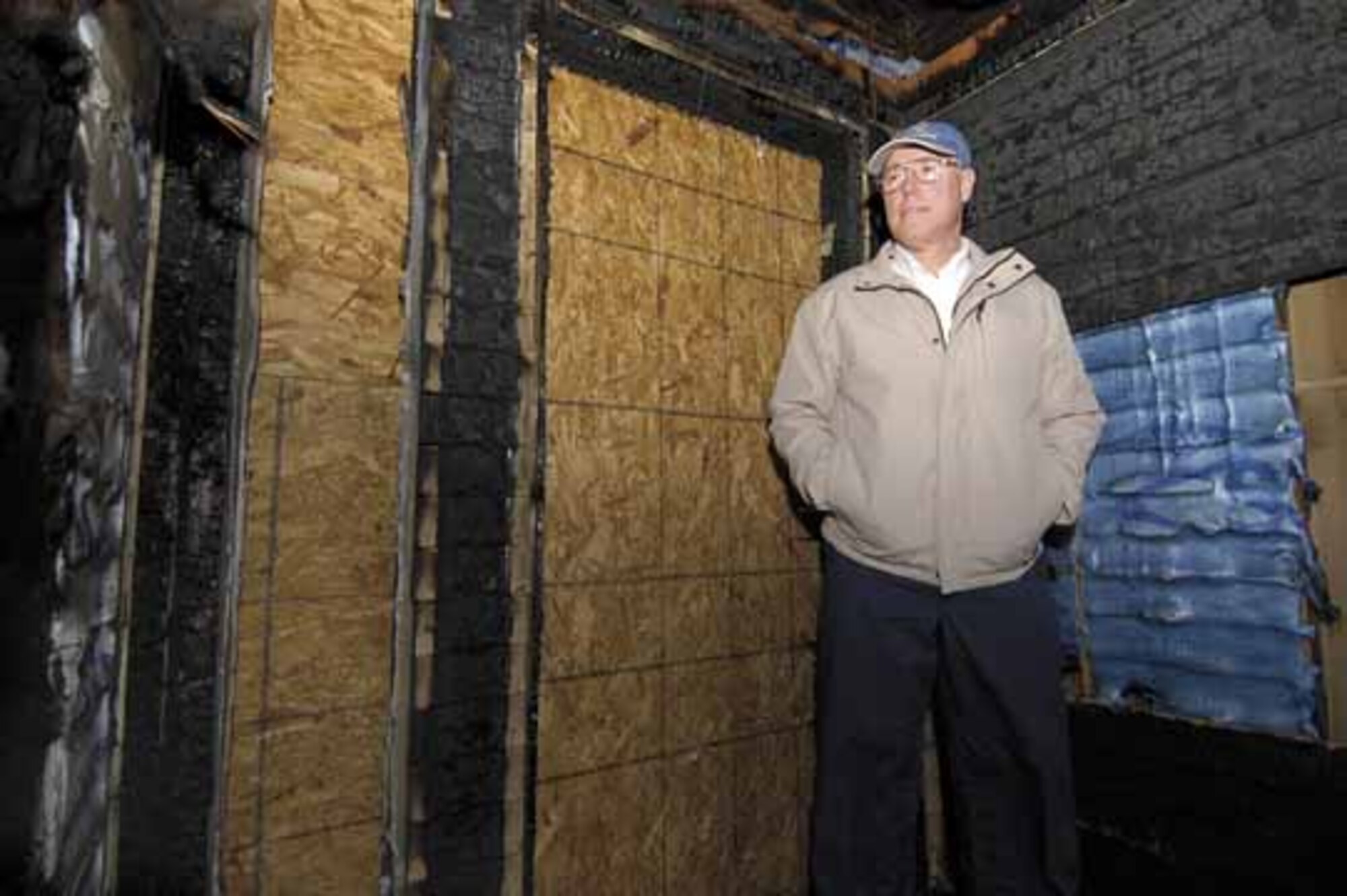 Bill Randall stands in the burned remains of a neighbor’s front porch where last month he stood yelling and pounding on the door to alert the family to the growing fire.  With pieces of burning roof dropping around him, the Tinker Air Force Base employee kicked in the door and ensured the family had escaped.  Besides applause from coworkers when he arrived late to work that day, Oklahoma City Fire Department officials recently honored him for heroism.