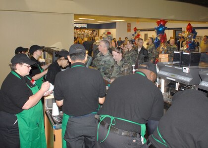 Baristas are busy serving the crowd following the Feb. 14 ribbon cutting ceremony for the newest coffee shop on Lackland Air Force Base, Texas. Located in the Basic Military Training Food Mall, Bldg. 7025, Starbucks will be open Monday-Friday from 6 a.m. to 8 p.m., and Saturday and Sunday from 7 a.m. to 8 p.m. Patrons who bring their own coffee mug will receive 10 cents off their purchase. (USAF photo by Robbin Cresswell)