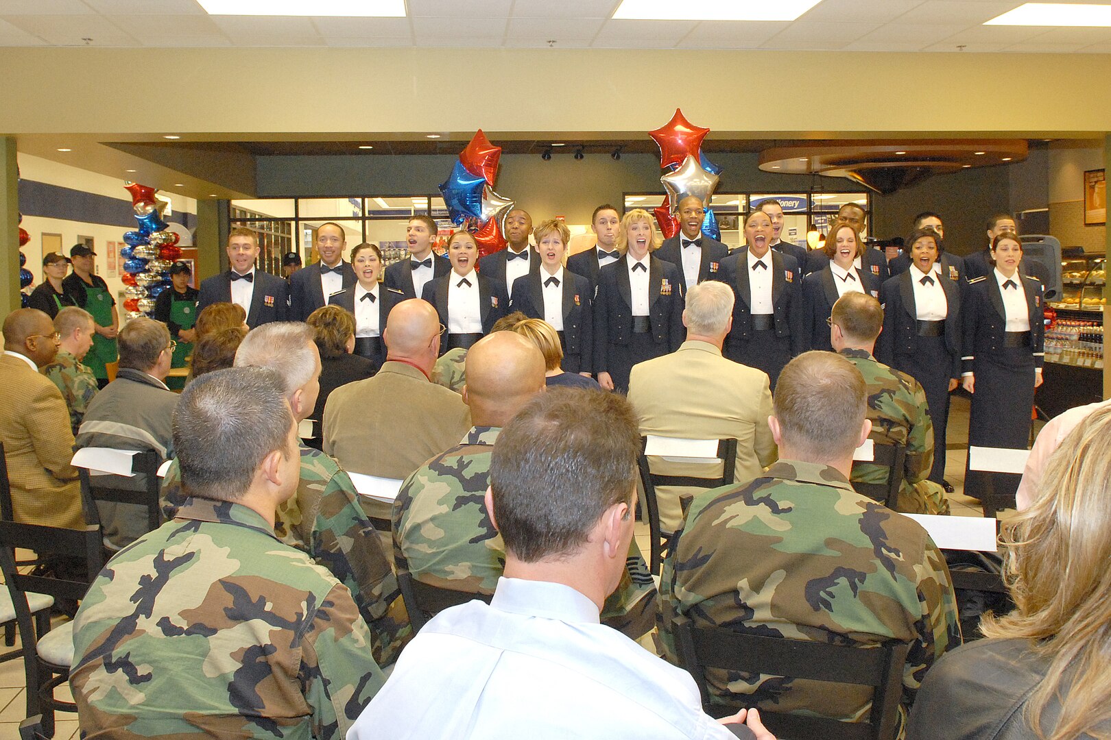 The 2007 Tops in Blue team from Lackland Air Force Base, Texas, make their first public appearance at the ribbon cutting ceremony of Lackland's Starbucks. Guests were eligible to enter for four drawings: a dozen roses, two $100 coffee gift cards and a 26-inch flat screen television. The television, donated by the Sabre Company, will be presented to Danielle Rutherford in a separate event. (USAF photo by Robbin Cresswell)