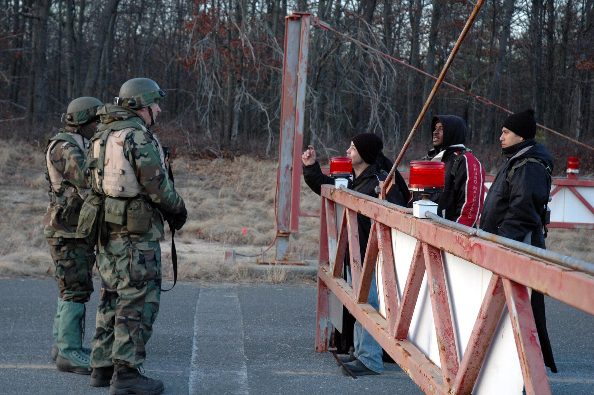 Airmen deployed with the 421st Air Expeditionary Group talk with "villagers" asking for food during operations for Eagle Flag Feb. 11 at the Naval Air Engineering Station in Lakehurst, N.J.  The exercise, operated by the Air Mobility Warfare Center's 421st Combat Training Squadron from Fort Dix, N.J., is set up to test Airmen on their expeditionary combat support skills.  (U.S. Air Force photo/Tech. Sgt. Scott T. Sturkol)
