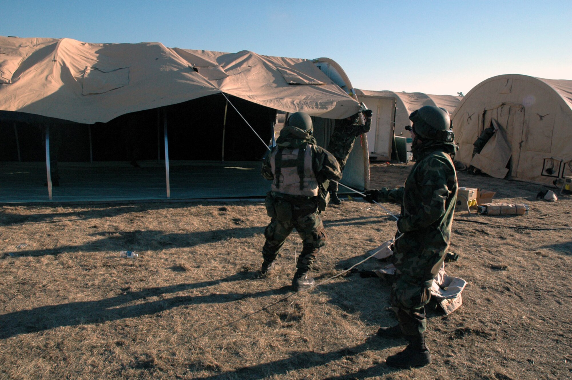 Airmen deployed with the 421st Air Expeditionary Group build an Alaskan tent during operations for Eagle Flag Feb. 11 at the Naval Air Engineering Station in Lakehurst, N.J.  The exercise, operated by the Air Mobility Warfare Center's 421st Combat Training Squadron from Fort Dix, N.J., is set up to test Airmen on their expeditionary combat support skills.  (U.S. Air Force photo/Tech. Sgt. Scott T. Sturkol)