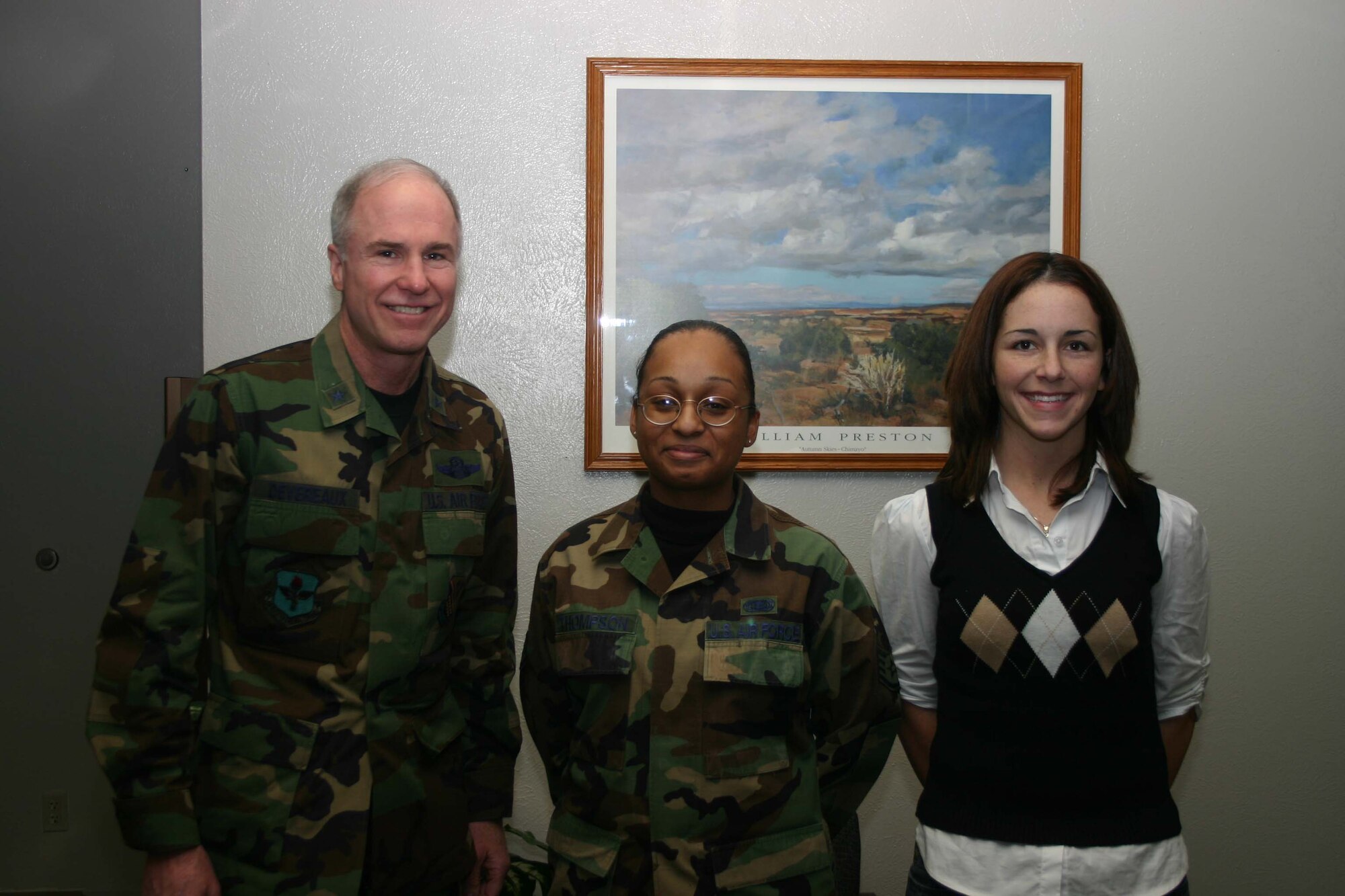 82nd Training Wing commander Brig. Gen. Richard Devereaux stands alongside Staff. Sgt. Tanisha Thompson and Tammy Drew. Sergeant Thompson and Ms. Drew were presented with wing coins in recognition of their confirmation of several wanted criminals while performing background searches, using the base's new automated tracking database. (U.S. Air Force Photo/Staff Sgt. Tonnette Thompson)
