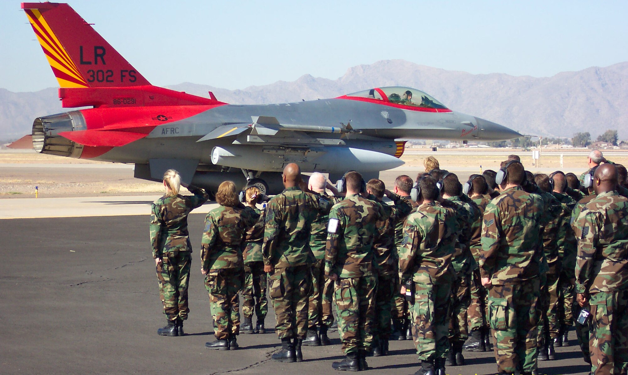 Members of the 944th Fighter Wing salute as Lt. Col. Donald Lindberg, 302nd Fighter Squadron commander, taxis to the runway Feb. 12, 2007, to depart for Nellis Air Force Base, Nev. The 302nd Fighter Squadron, which traces its roots to the Tuskegee Airmen, will be inactivated at Luke AFB but will return to the Air Force Reserve Command when it stands up as an F-22 associate unit at Elmendorf AFB, Alaska. (U.S. Air Force photo/Bryce Watson)