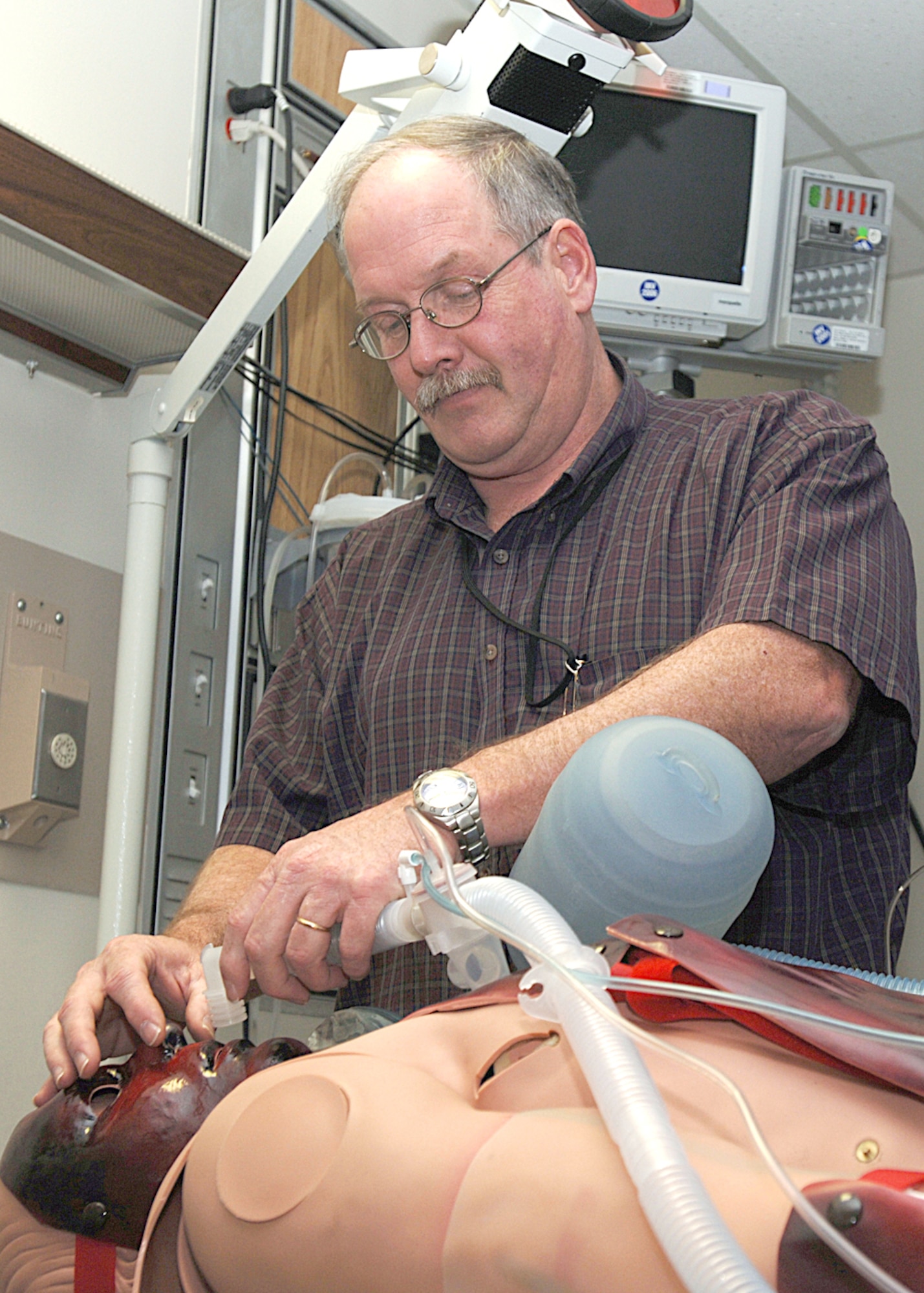 John Mechtel sets up a replicated burn victim's airway in one of the simulation center's scenario rooms at Wilford Hall Medical Center Feb. 9 at Lackland Air Force Base, Texas. The center has trained more than 1,400 people since July 2005 and has the capability to train complex medical concepts using virtual reality simulators, task trainers and high-fidelity mannequins that respond correctly to procedures and therapies rendered by medics. Mr. Mechtel is the 59th Medical Wing Simulation Center program manager. (U.S. Air Force photo/Staff Sgt. Ruth Stanley)