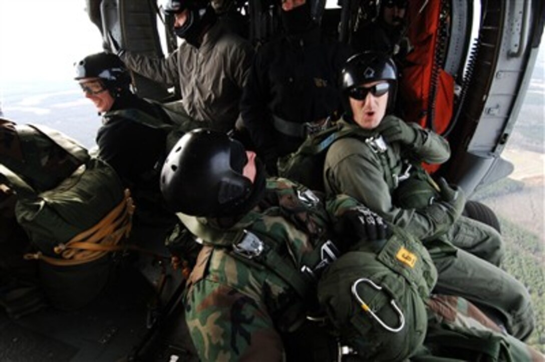 U.S. Navy Explosive Ordnance Disposal Technicians from Explosive Ordnance Disposal Unit Two prepare to conduct a static-line parachute jump operation from an MH-60S Seahawk helicopter at Fort Pickett, Va., on Feb. 8, 2007.  