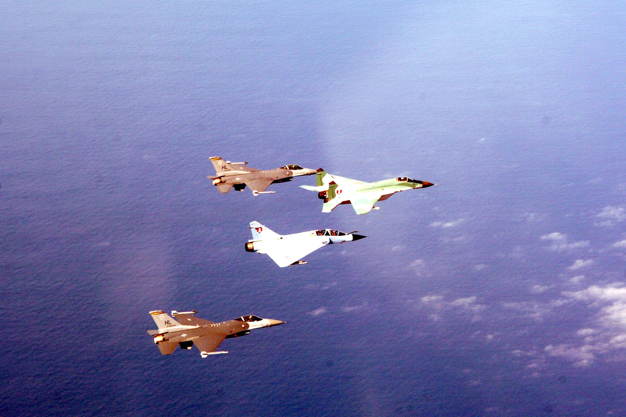Two F-16 Fighting Falcons form up with a Peruvian MiG-29 and Mirage 2000 during dissimilar air combat training Feb. 15 as part of Falcon and Condor 2007, a joint exercise between the U.S. and Peruvian Air Forces. The exercise allows the U.S. military to build relationships with military and civilian leaders of Peru. The F-16s are from the 34th Fighter Squadron at Hill Air Force Base, Utah. (U.S. Air Force photo/Tech. Sgt. Eric Kreps)