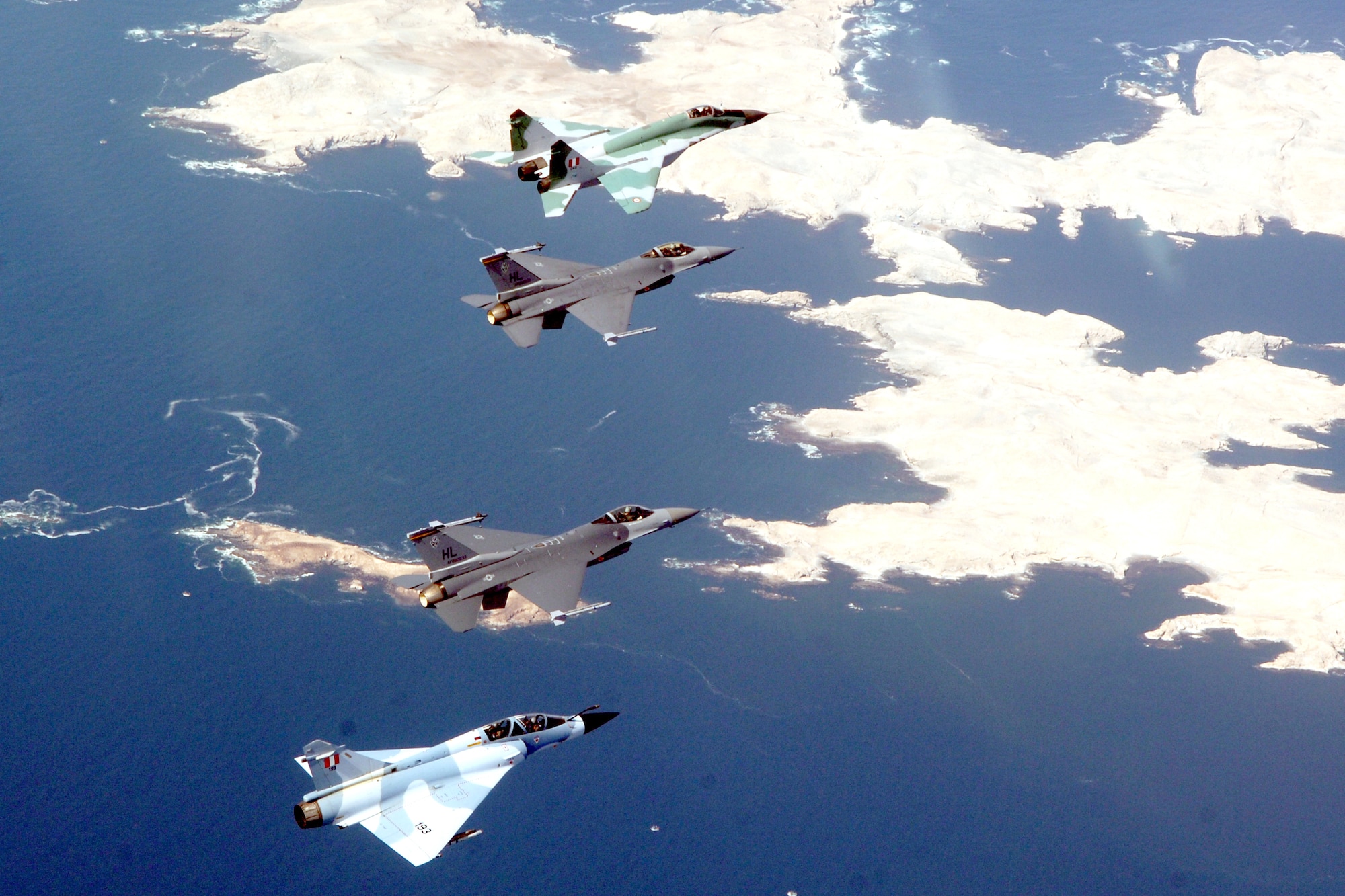 Two F-16 Fighting Falcons form up with a Peruvian MiG-29 and Mirage 2000 during dissimilar air combat training Feb. 15 as part of Falcon and Condor 2007, a joint exercise between the U.S. and Peruvian Air Forces. The exercise allows the U.S. military to build relationships with military and civilian leaders of Peru. The F-16s are from the 34th Fighter Squadron at Hill Air Force Base, Utah. (U.S. Air Force photo/Tech. Sgt. Eric Kreps)