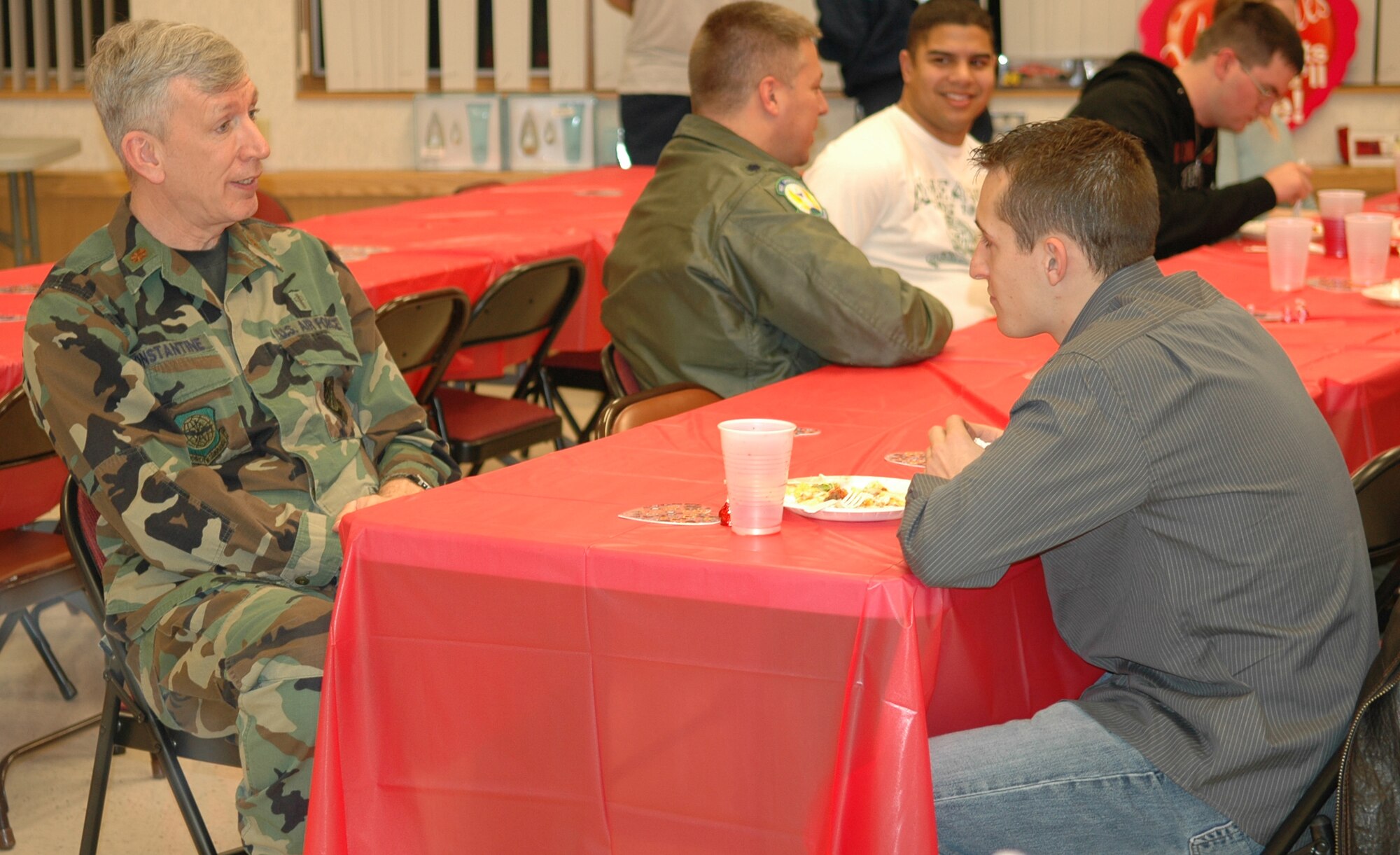 Chaplain (Maj.) Bill Constantine, 92nd Air Refueling Wing, talks about different areas of the United States with Airman 1st Class James Goglia, 92nd Civil Engineer Squadron explosive ordnance disposal. Once a month, the chapel and a different organization on base host a dinner, which is open to single servicemembers. This month’s dinner was hosted by the 92nd Operations Support Squadron. (U.S. Air Force photo/Staff Sgt. Larry Carpenter)