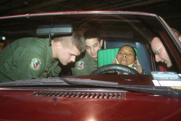 WRIGHT-PATTERSON AFB, Ohio -- (left to right): In a simulated truck wreck Senior Airmen Bryan Johnson and Keith Beckerich from the 445th Aeromedical Evacuation Squadron help place a Kendrick Extrication Device, used to stabilized a victim's spine, on Staff Sgt. Elizabeth Robinson from the 910th Medical Squadron while Tech. Sgt. Frank Oliver also from the 445th AES assists. (U.S. Air Force photo/Maj. Ted Theopolos)