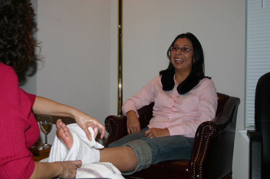 LAUGHLIN AIR FORCE BASE, Texas -- Maria Seighman enjoys a well-deserved foot massage during the Airman and Family Readiness Center’s spa night Feb. 10.  Mrs. Seighman’s husband left in January for his second year-long tour in Iraq.  The spa night was designed to help the spouses of deployed members unwind and relax.  (U.S. Air Force photo by 2nd Lt. Courtney Kippenberger)  
