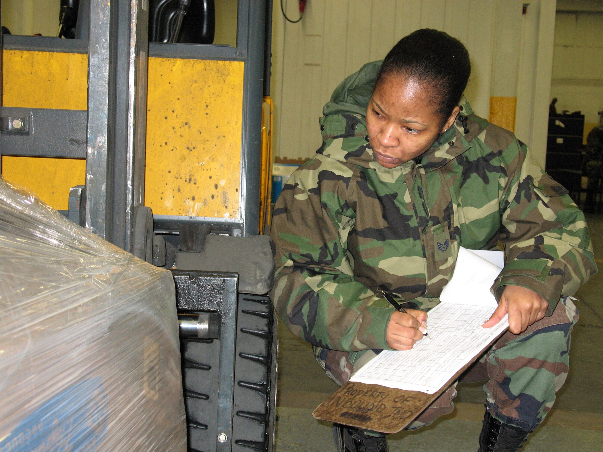 Staff Sgt. Niki Lee checks a pallet Feb. 14 at the Cargo Movement Center inbound section at Ramstein Air Base, Germany. Every year the inbound section receives approximately 30,000 shipments from around the world.  (U.S. Air Force photo/Staff Sgt. Leigh Bellinger)