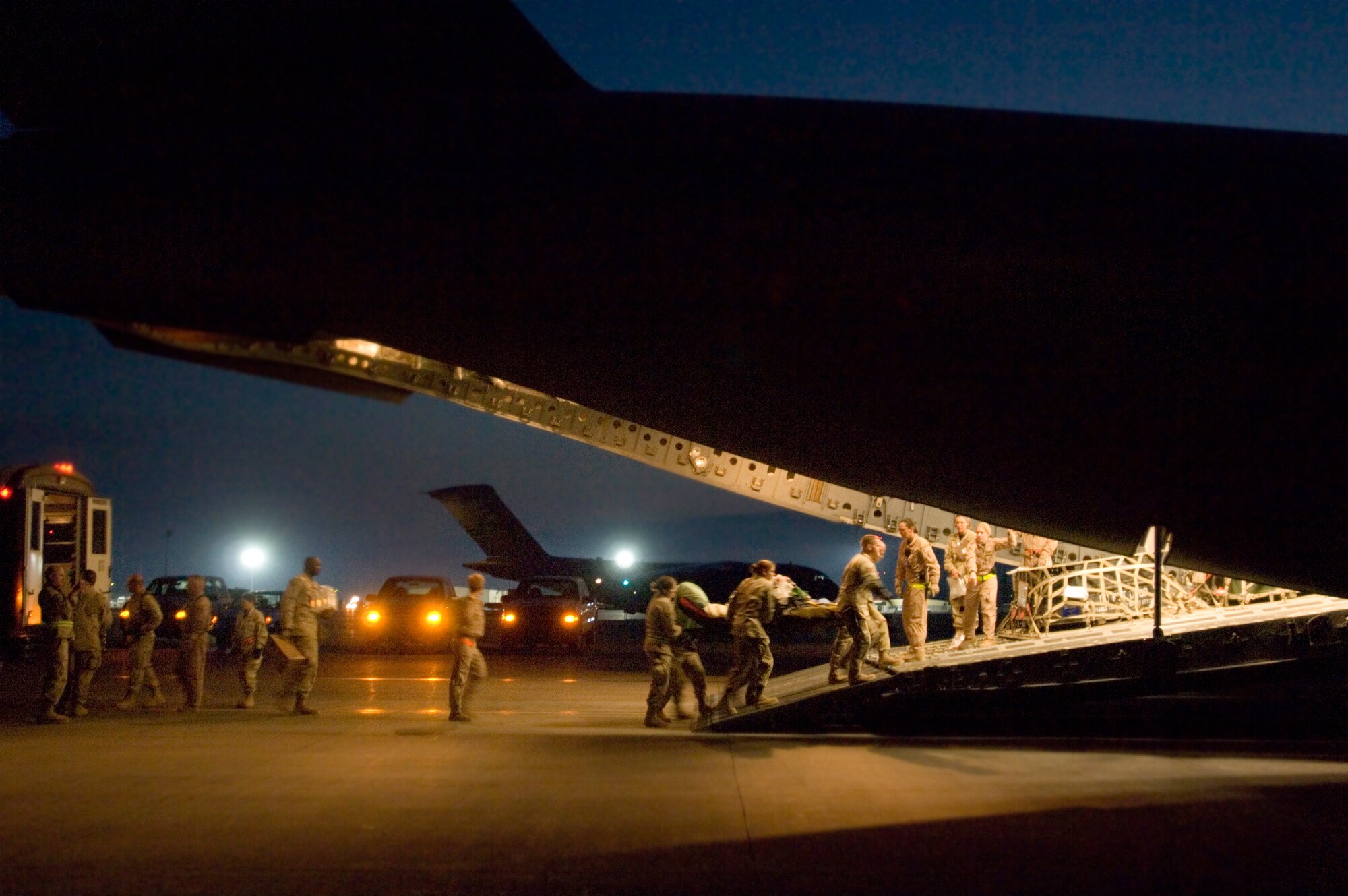 Contingency aeromedical staging facility team members prepare a critical-care patient Feb. 14 for transport on C-17 Globemaster III to Landstuhl, Germany, where he will receive further care for his wounds at Balad Air Base, Iraq. (U.S. Air Force photo/Tech. Sgt. Cecilio M. Ricardo Jr.)