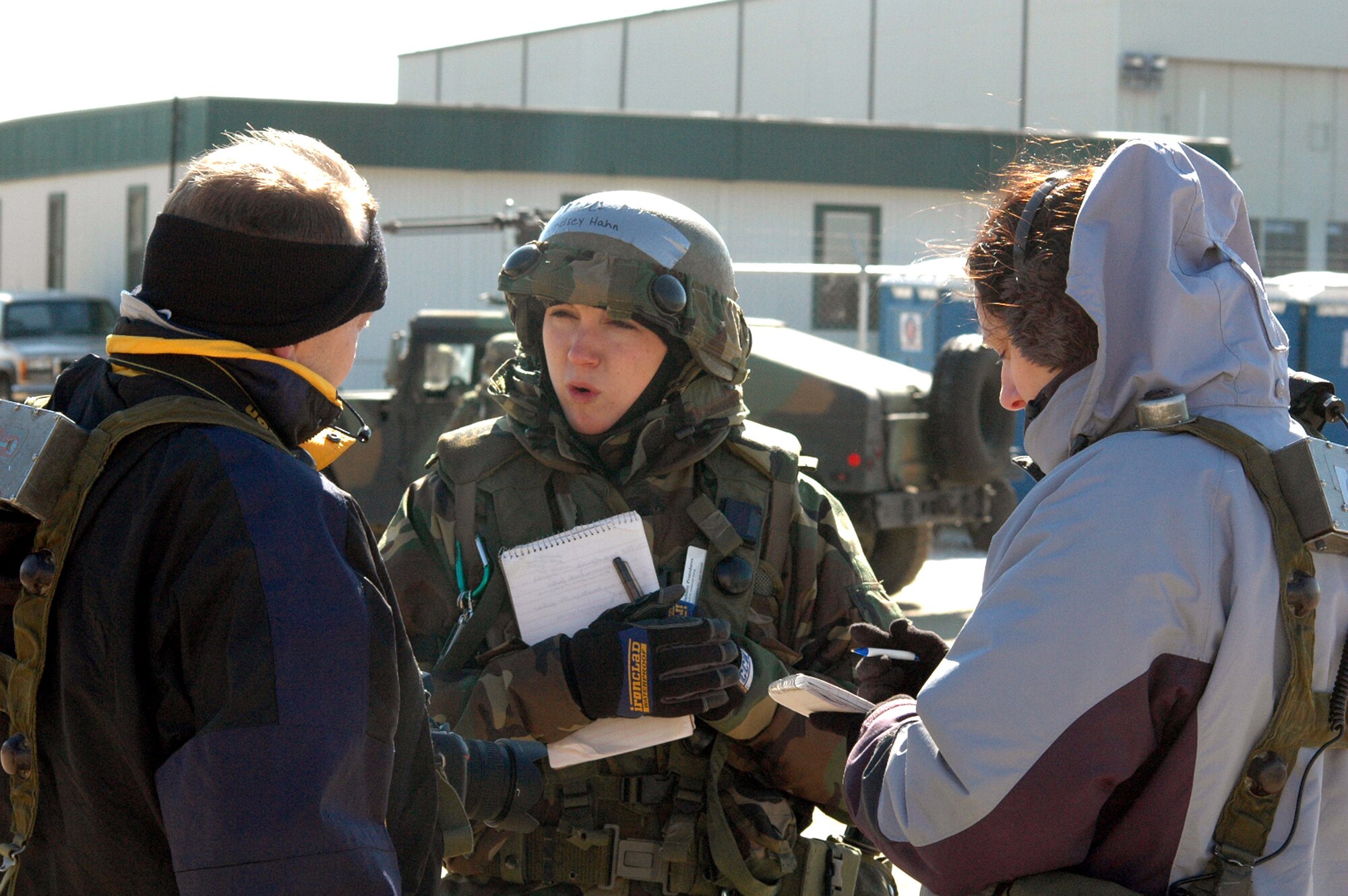 1st Lt. Lindsay Hahn talks with "host nation" reporters played by Tech. Sgt. Ron Rogers and Master Sgt. Melissa Phillips during a scenario for Exercise Eagle Flag 07-3 Feb. 10 at Naval Air Engineering Station Lakehurst, N.J. The exercise, operated by the Air Mobility Warfare Center's 421st Combat Training Squadron, tests and trains more than 400 Airmen on their expeditionary combat support skills. Lieutenant Hahn is a public affairs officer from Travis Air Force Base, Calif., Sergeant Rogers is a broadcaster from the Air Force News Agency in San Antonio, and Sergeant Phillips is a public affairs superintendent at Dover Air Force Base, Del. (U.S. Air Force Photo/Tech. Sgt. Scott T. Sturkol)