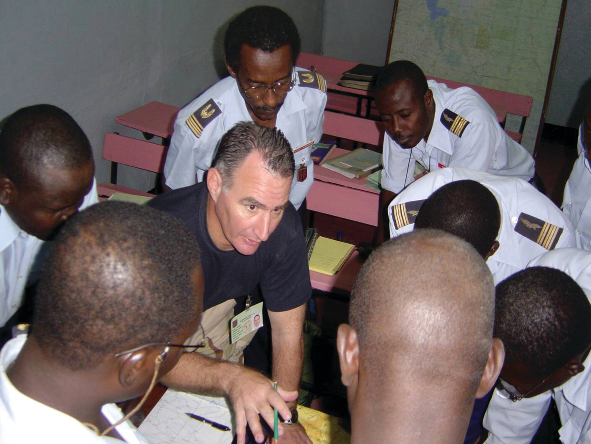 A 6th Special Operations Squadron advisor acts as an ambassador, explaining low-level delivery operations to Chadian air force C-130 crew members during a recent mission. Courtesy photo.