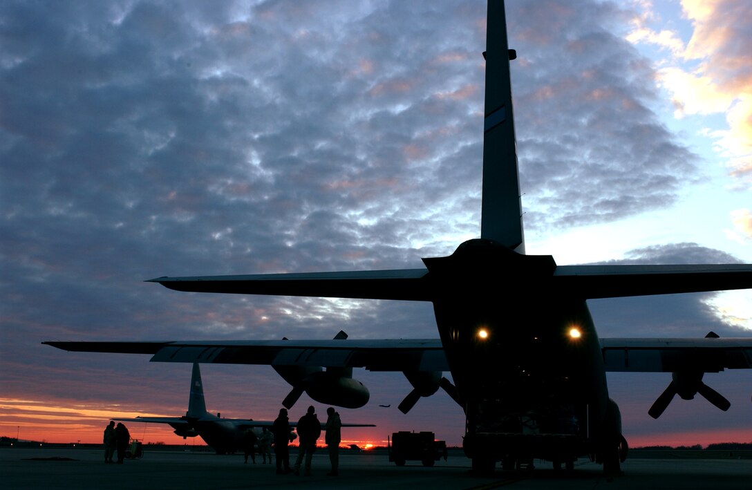 Flight crew members begin to preflight and board a C-130 Hercules bound for a mission to Southwest Asia Feb. 6 at Charlotte, N.C. The Airmen are assigned to the 145th Airlift Wing, North Carolina Air National Guard.  The aircraft is capable of operating from rough, dirt strips and is the prime transport for air dropping troops and equipment into hostile areas. (U.S. Air Force photo/Tech. Sgt. Brian E. Christiansen) 
