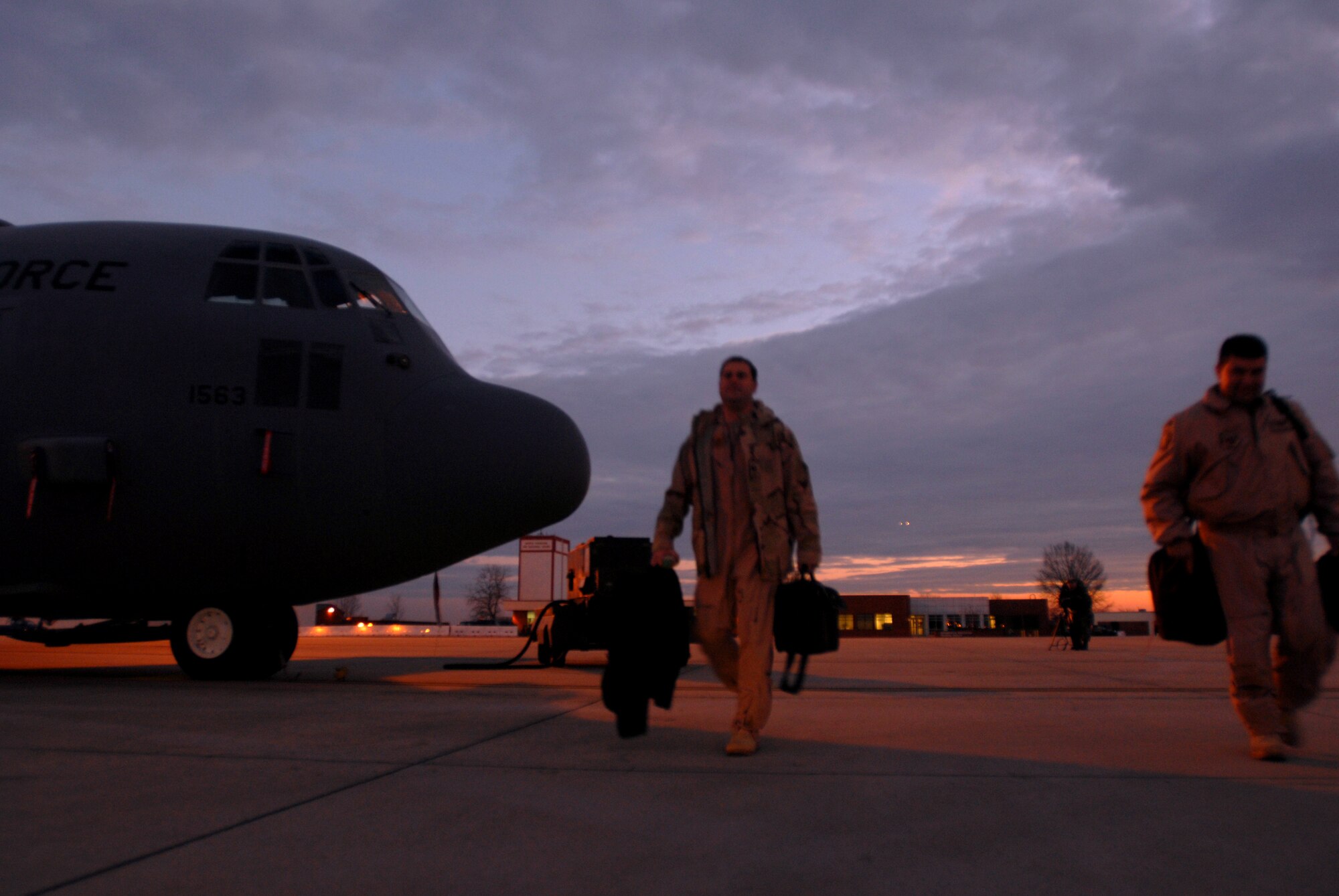 North Carolina Air National Guard members make their way to their C-130 Hercules Feb. 6 at Charlotte, N.C. The Airmen are assigned to the 145th Airlift Wing and will be deploying in support of Enduring Freedom. The C-130 can accommodate a wide variety of oversized cargo, including everything from utility helicopters and six-wheeled armored vehicles to standard palletized cargo and passengers. (U.S. Air Force photo/Tech. Sgt. Brian E. Christiansen)