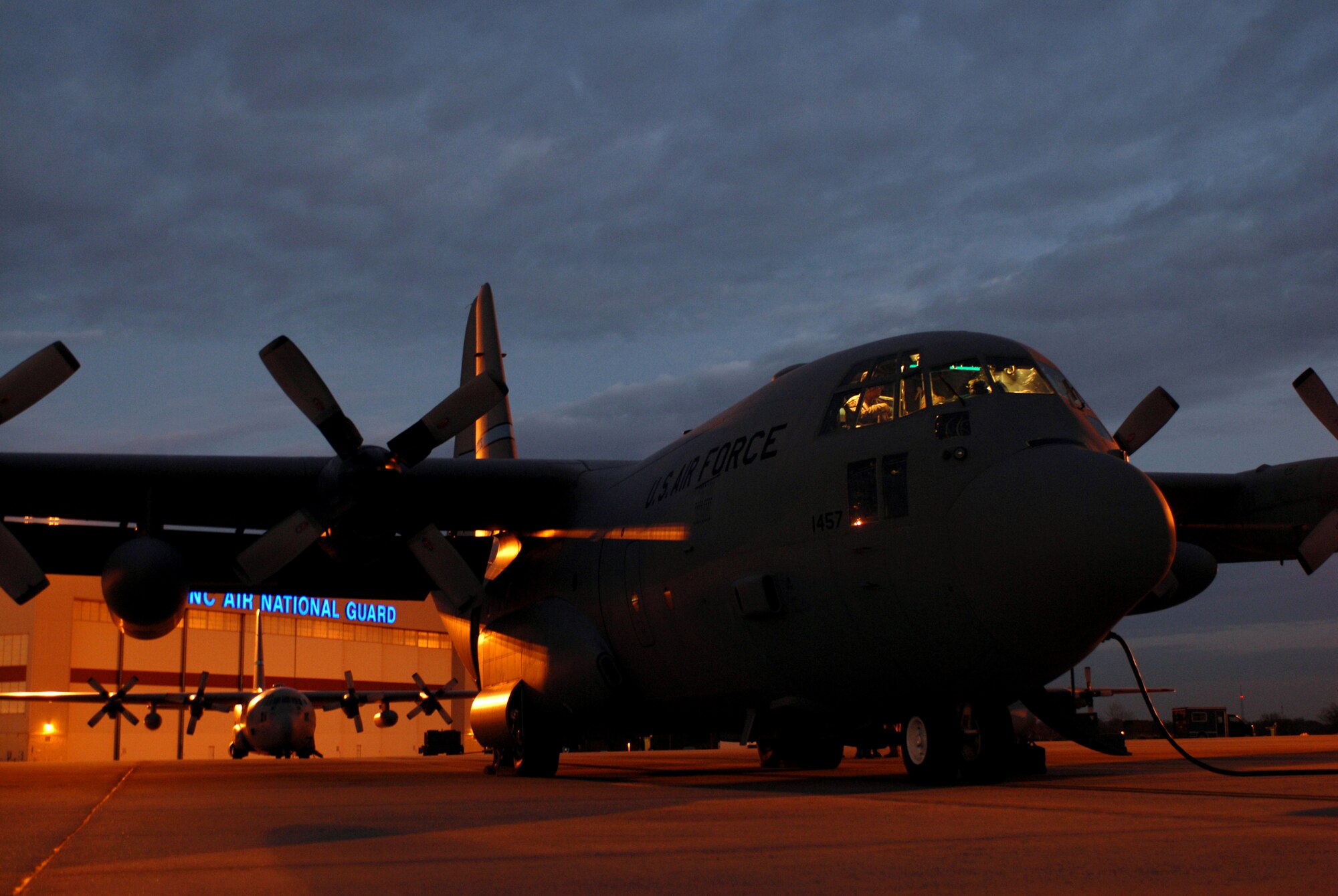 Flight crew members begin to preflight a C-130 Hercules for a routine night mission for the 145th Airlift Wing of the North Carolina Air National Guard Feb. 6 at Charlotte, N.C. The aircraft is capable of operating from rough, dirt strips and is the prime transport for air dropping troops and equipment into hostile areas. (U.S. Air Force photo/Tech. Sgt. Brian E. Christiansen)
