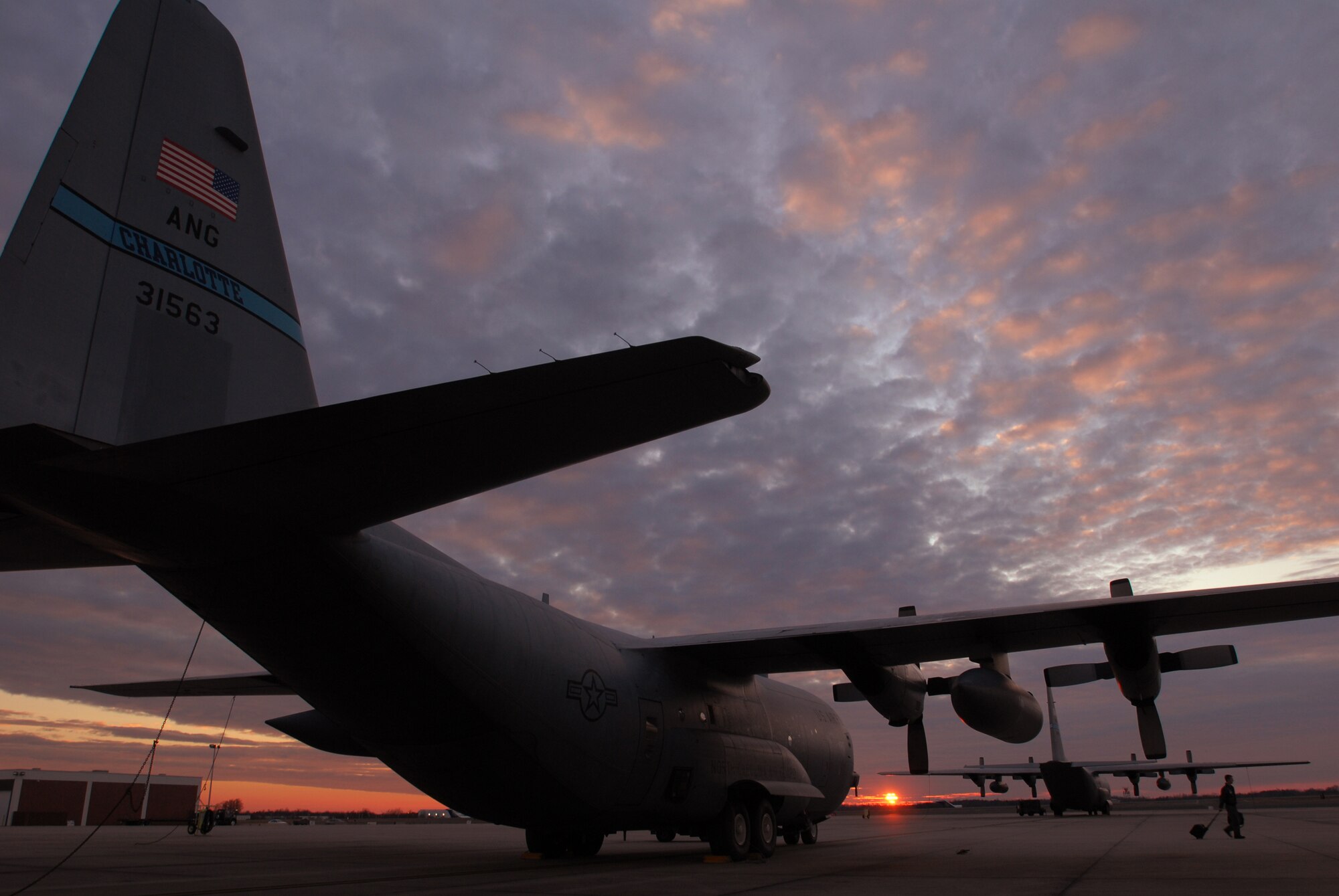 C-130 Hercules aircraft sit on the flight line Feb. 6 at sunset in Charlotte, N.C. The Air National Guard's 145th Airlift Wing aircraft and Airmen are preparing to deploy in support of Operation Enduring Freedom. (U.S. Air Force photo/Tech. Sgt. Brian E. Christiansen) 