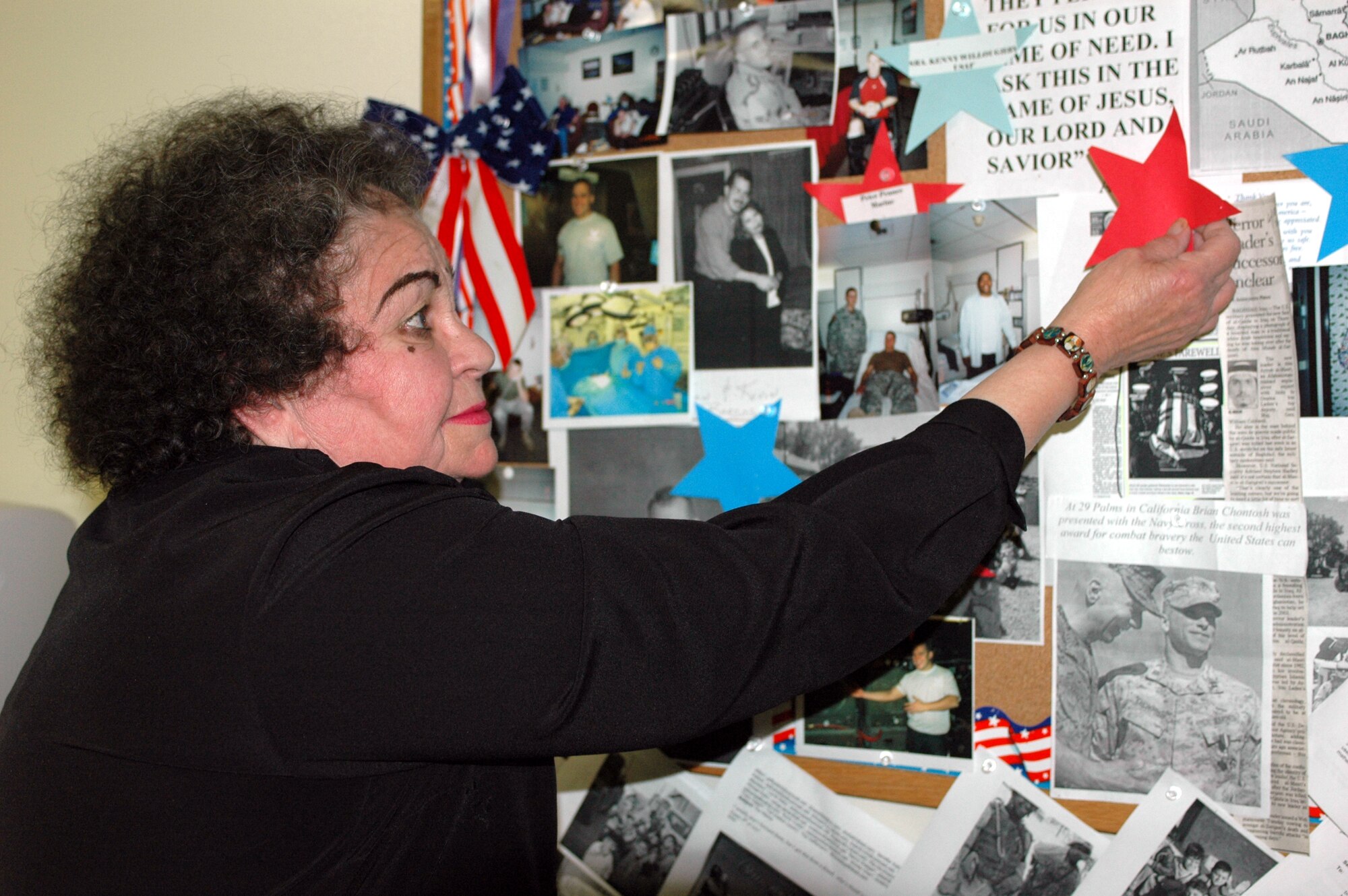 Mrs. Bunny Dominguez, director of the David Grant USAF Medical Center’s Retiree Activities Office, pins a star onto her “troops” board. Known for her “bunny hugs,” Mrs. Dominguez has been volunteering at various military locations for nearly 40 years. (U.S. Air Force photo by Staff Sgt. Candy Knight)