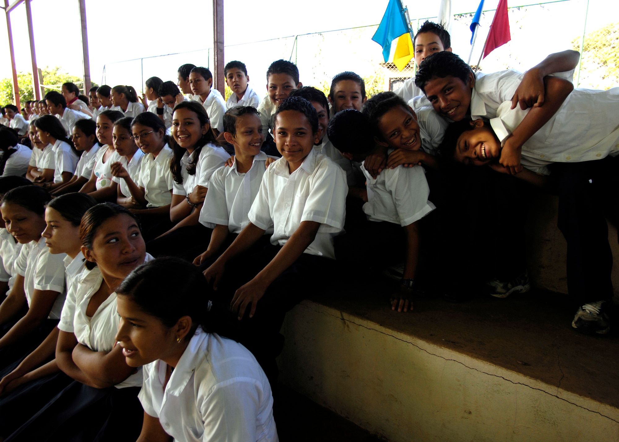 Resident school children of Santa Teresa watch as members of the 820th Expeditionary Red Horse Squadron, as well as Nicaraguan military and government officials, participate Feb. 15 in the opening ceremonies of New Horizons-Nicaragua 2007. New Horizons-Nicaragua 2007 is a $7.25 million United States and Nicaraguan military humanitarian and training exercise that is providing a new school and medical clinic to the Nicaraguan people. U.S. military members will also administer free health to Nicaraguans and free veterinary care to animals. (U.S. Air Force photo/Tech. Sgt. Kevin P. Milliken)