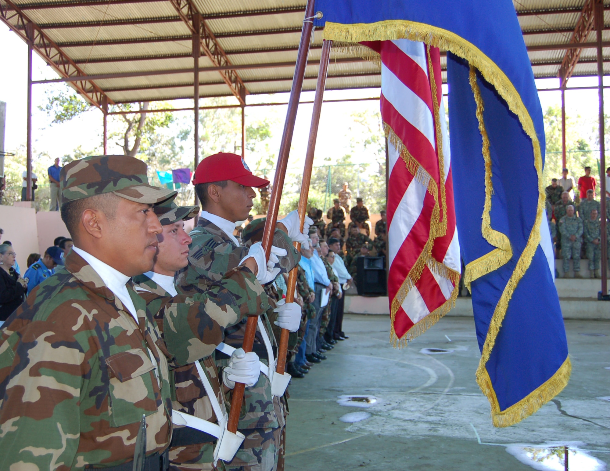 Senior Airman Jesus Cortez, member of the 820th Expeditionary Red Horse Squadron out of Nellis Air Force Base, Nev., along with Nicaraguan army Sgt. 3rd Class Juan Ramon Bado and Soldiers Marcos Mercado and Vladmir Perez, present flags from both countries during the New Horizons - Nicaragua 2007 opening ceremonies Feb. 15. (U.S. Air Force photo/Senior Airman Jacque Lickteig)