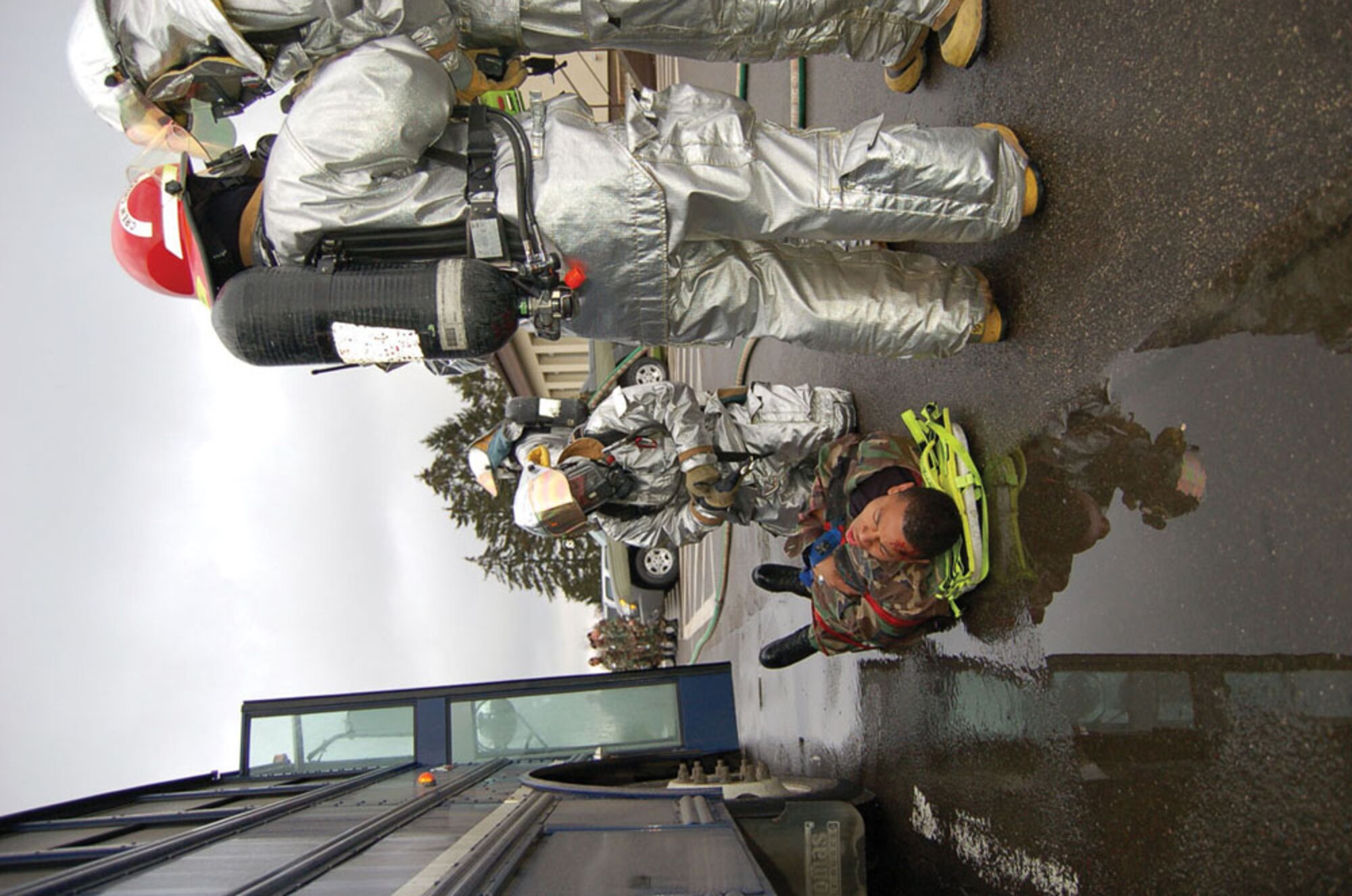 SPANGDAHLEM AIR BASE, GERMANY -- Firefighters strap a “victim” to a litter during the exercise and prepare to carry him to a safe location.   (US Air Force photo by Senior Airman Eydie Sakura)