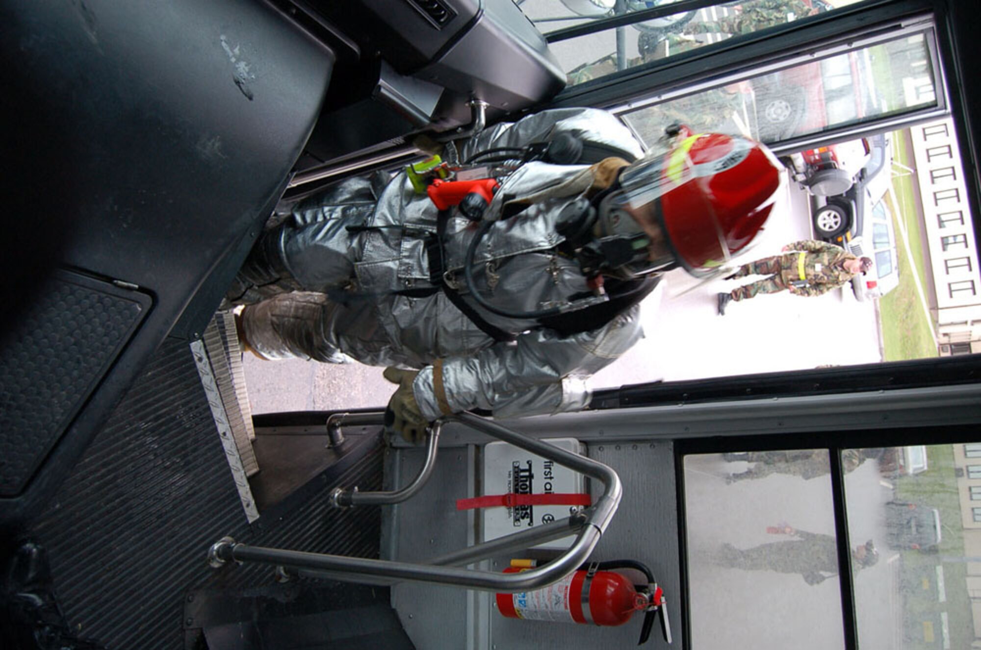 SPANGDAHLEM AIR BASE, GERMANY -- A 52nd Civil Engineer Squadron firefighter climbs the steps of a bus that was part of a simulated multi-vehicle accident Feb. 9.   (US Air Force photo by Senior Airman Eydie Sakura)