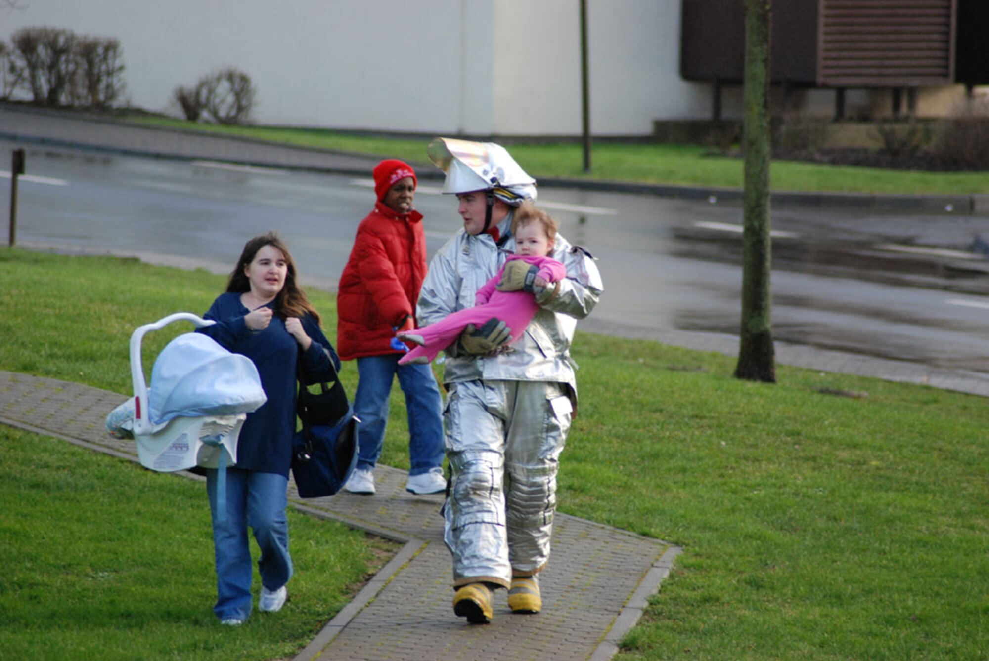 SPANGDAHLEM AIR BASE, GERMANY -- When a suspicious package was found at the Bitburg Annex shoppette Tuesday Matthias Meyer, 52nd Civil Engineer Squadron Fire and Emergency Services Flight fire fighter, helped a woman move her children to a secure area. (US Air Force photo by Nick Anderson)