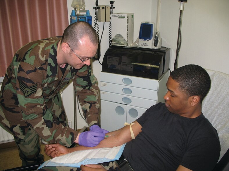SPANGDAHLEM AIR BASE, GERMANY -- Staff Sgt. Leslie Cook, 52nd Medical Operations Squadron aerospace medical technician, practices inserting an IV needle. Sergeant Cook is on a list of people who could be cross-trained into a related medical job specialty under the Air Force force shaping program. (US Air Force photo by Tech. Sgt. Gene Taylor)