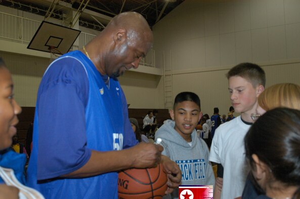 YOKOTA AIR BASE, Japan -- Joe "Jellybean" Bryant, father of Kobe Bryant and coach of the Tokyo Apache basketball team, takes time to sign autographs and talk to fans after the game Feb. 7 at the Samurai Fitness Center. Bryant also played during the last half of the game. Tokyo Apache, a Japanese professional basketball team, took on the Yokota Warriors varsity team here and walked away with the win, 96 - 74, while approximately 200 Yokota members looked on. (U.S. Air Force photo by Mark Allen)                                