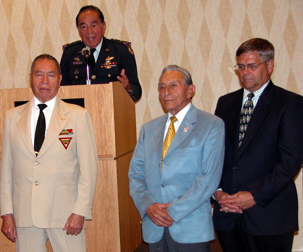 Mexican Col. Carlos Garduno, World War II Aztec  Eagles pilot, at podium, said only 10 of more than 300 Mexican pilots  who fought with the U.S. Army Air Forces in the Pacific are still  alive. He and former pilot Capt. Miguel Moreno Arreolla, left front,  and ground crewman, Capt. Manuel Cervantes Ramos, center, were able to  attend a DoD Hispanic American Heritage Month observance at the Hyatt  Regency Orange County Hotel in Anaheim, Calif., Oct. 16. At right is  Charles Abell, principal deputy undersecretary of defense for personnel  and readiness. Photo by Rudi Williams