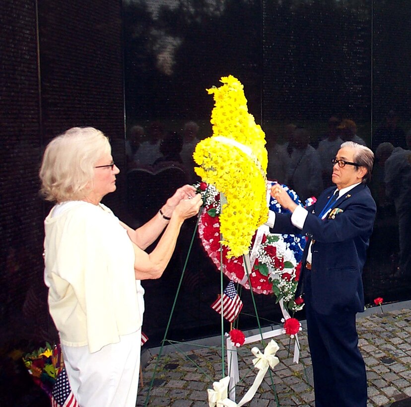 Ann Y. Sherman Wolcott and former South  Vietnamese army colonel Nguyem Kim Ban, who spent more than  17 years in a North Vietnamese prisoner of war camp, place  the annual yellow American Gold Star Mothers wreath at the  Vietnam Veterans Memorial Sept. 28 on Gold Star Mothers  Day, the last Sunday of September. Wolcott is the  organization's president. Photo by Rudi Williams.