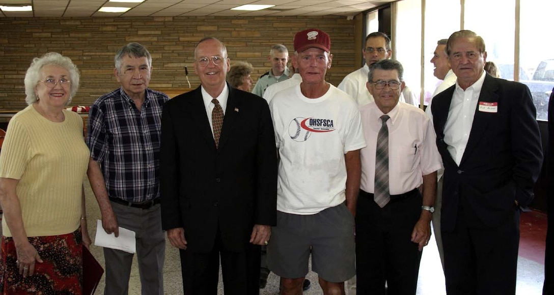Assistant Secretary of Defense for Reserve Affairs Thomas F.  Hall poses with some of his hometown educators during ceremonies Sept. 10 to  rename 8th Street in Barnsdall, Okla., as Rear Admiral Tom Hall Avenue.  Representing more than 200 combined years of education experience were, left to  right, William Logue, high school speech and English teacher; Andy Vann, Hall's  elementary school teacher; Hall; Joe Gilbert, his baseball and basketball  coach; and Charlie Brooks and Joe Baker, both former teachers and principals.  Photo by Stephen Overaker, courtesy of the Barnsdall Times