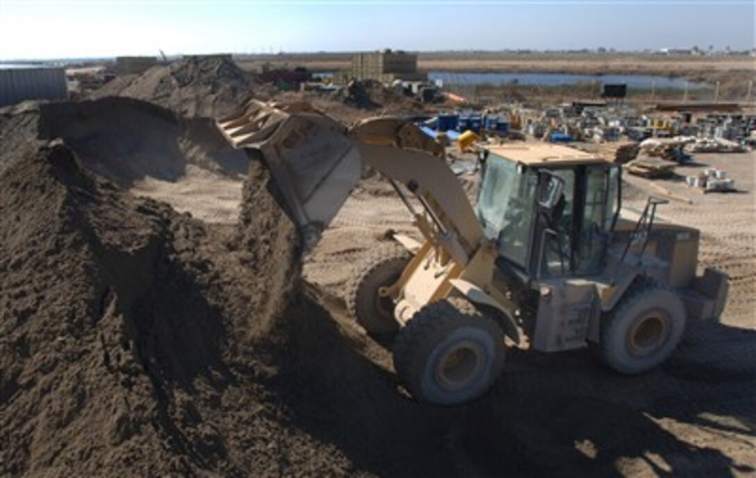 U.S. Air Force Airman 1st Class Michael Jameson, from 332nd Expeditionary Civil Engineers Squadron, uses a 2.5 cubic yard front-end loader to consolidate material used to prepare construction sites and repair airfield pavements on Balad Air Base, Iraq, Feb. 12, 2007. 