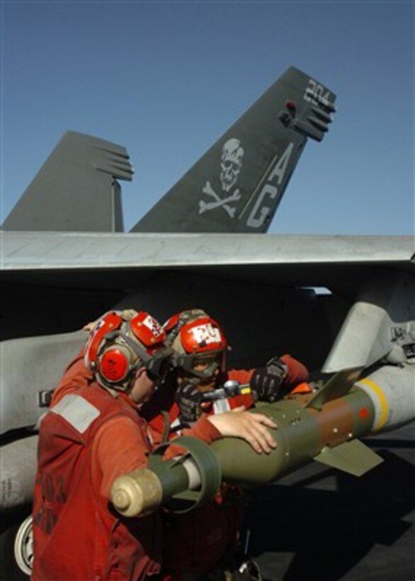 U.S. Navy sailors lock down a missile on an F/A-18F Super Hornet aircraft aboard the aircraft carrier USS Dwight D. Eisenhower (CVN 69) on Feb. 10, 2007.  The Eisenhower is underway in the Arabian Sea in support of maritime security operations. 