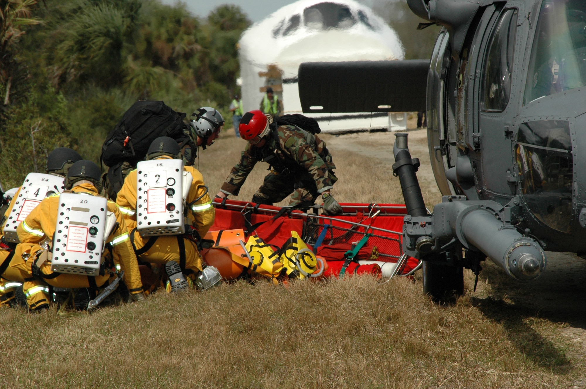 308th Rescue Squadron pararescuemen and NASA emergency firefighters offload emergency equipment from a 301st RQS HH-60 Pave Hawk for an exercise at Cape Canaveral Air Force Station, Fla. Feb. 13. The exercise allowed rescue workers to train in egress and encompassed NASA, the 45th Space Wing and the Air Force Reserve's 920th Rescue Wing, both at Patrick Air Force Base. (U.S. Air Force photo/1st Lt. Cathleen Snow)