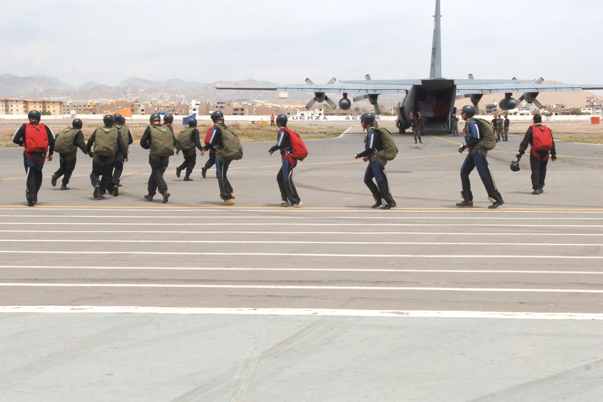 A crew of 13 Peruvian special forces members load a U.S. C-130 Hercules from the Puerto Rico Air National Guard Feb. 17 in preparation for jump during the joint air show at Las Palmas Air Force Base in Lima, Peru. Falcon Condor 2007 is a joint exercise and air show that directly supports the U.S. Southern Command's engagement goals. (U.S. Air Force photo/Tech. Sgt. Kerry Jackson)