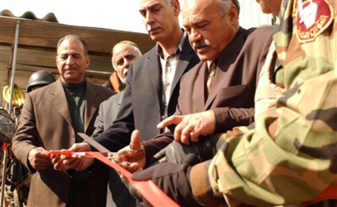 Local council members cut the ribbon marking the opening of the Al Rasheed market in Baghdad, Iraq, Feb. 17, 2007. Insurgents attacked this market a year ago putting traders out of business and the community without a place to shop but now, with more security around the market, life has returned to this once busy market. 