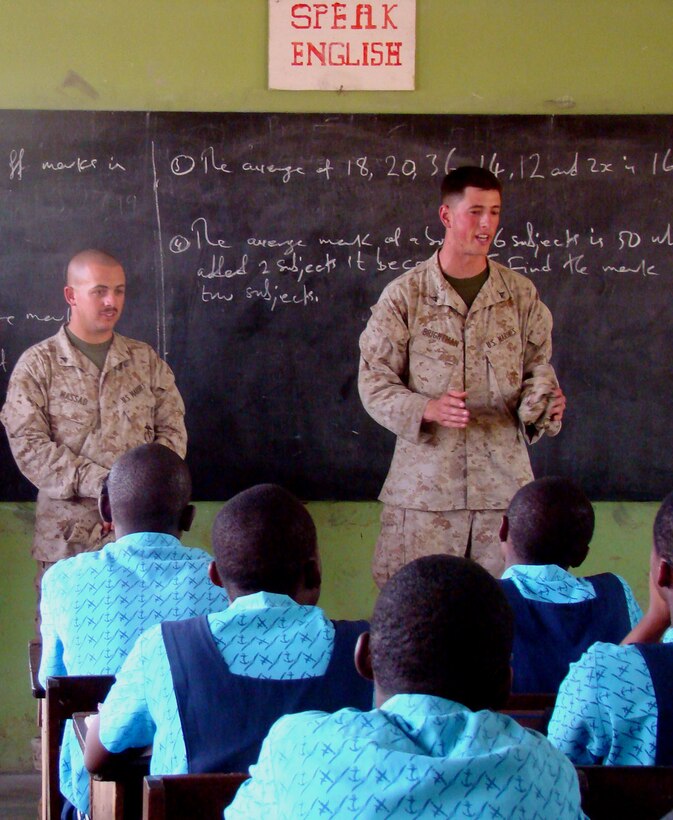 ACCRA, Ghana – Lance Corporals Joshua Brightman and Michael Massad, a team leader and security forces Marine respectively, with the 2nd Fleet Anti-terrorism Security Team Europe, 6th Platoon, share thoughts and experiences with students at the Air Force Base School here Feb. 19. U.S. Marines out of Rota Naval Air Station, Spain, visited the school to answer questions from the students and stress the importance of staying in school. U.S. Armed Forces members are in Accra as part of a joint task force providing infrastructure, aircraft and personnel in support of the President's visits to Benin, Tanzania, Rwanda, Ghana and Liberia Feb. 16 to 21. (U.S. Air Force photo by Tech. Sgt. Denise Johnson)