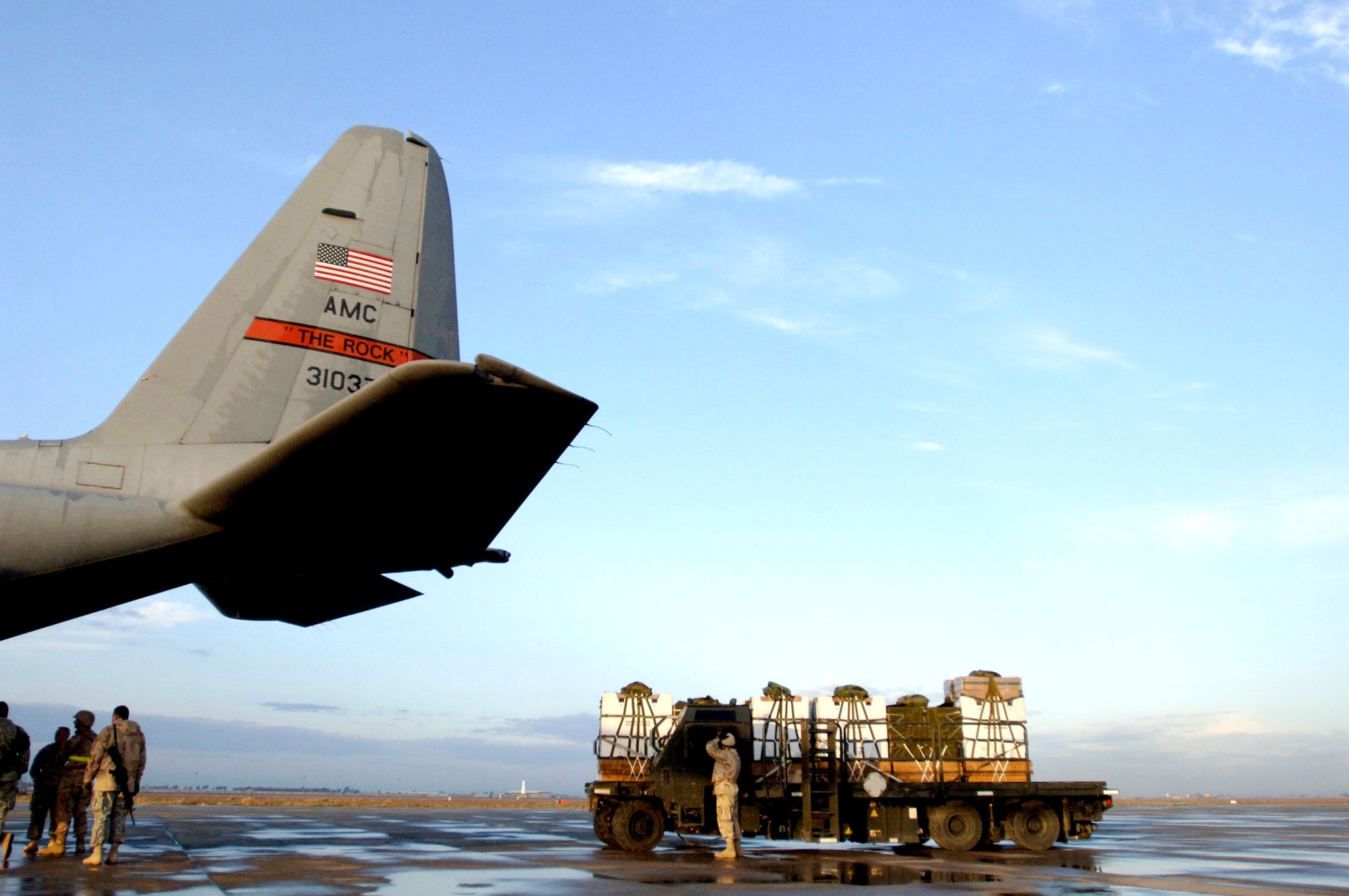 Aerial port members load six 1,200-pound bundles of water and Meals, Ready to Eat onto a C-130 Hercules Feb. 16 at Balad Air Base, Iraq, in preparation for the first Improved Container Delivery System airdrop mission in support of Operation Iraqi Freedom. The aerial port members are assigned to the 332nd Expeditionary Logistics Readiness Squadron. (U.S. Air Force photo/Tech. Sgt. Cecilio M. Ricardo Jr.) 