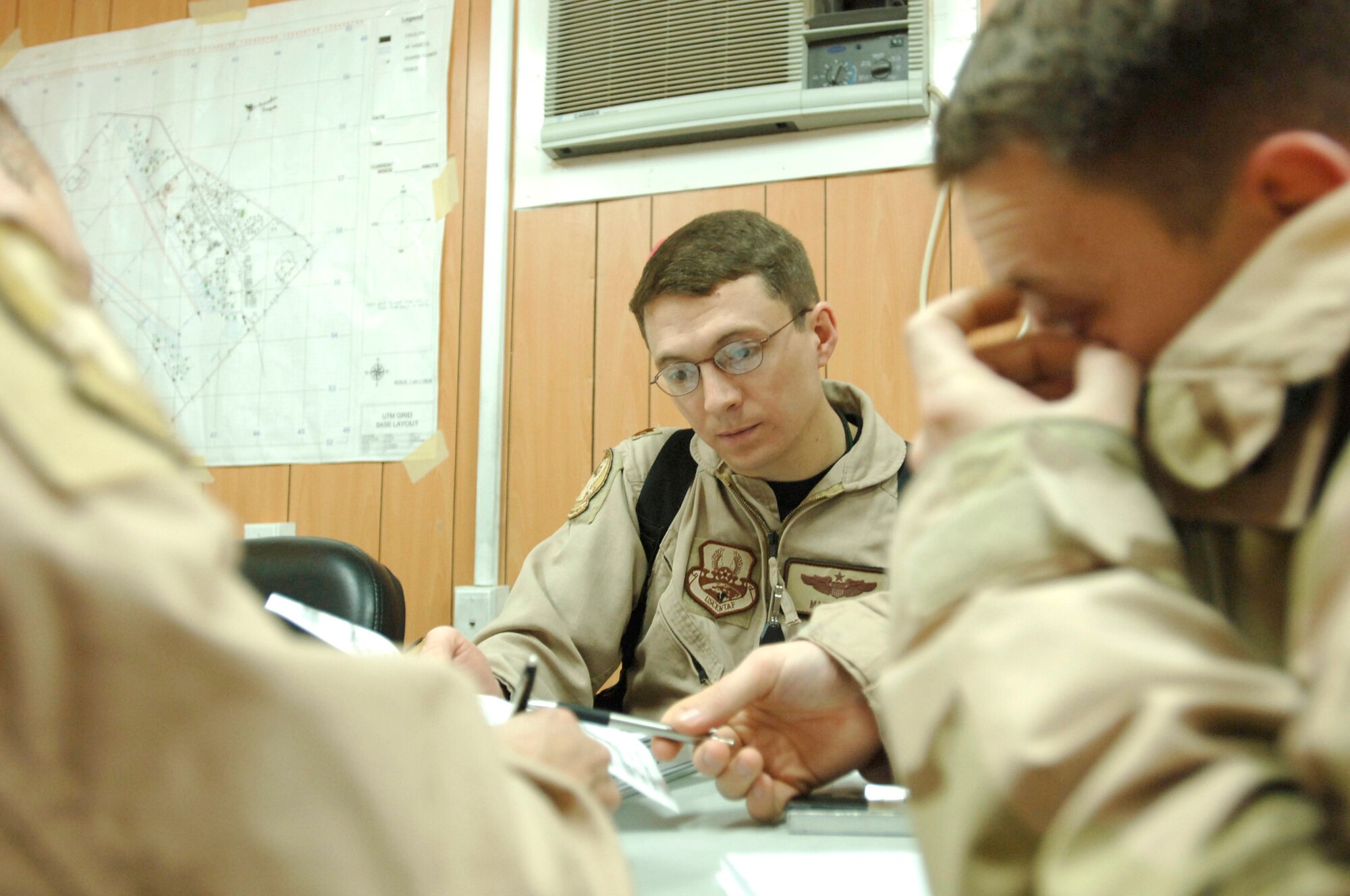Maj. Matt Lewis briefs his crew in preparation to employ the Joint Precision Airdrop System in combination with the Improved Container Delivery System for the first time in Operation Iraqi Freedom Feb. 16. Pairing the JPADS mission planning software with the I-CDS bundles increases airdrop accuracy by 60 percent. Major Lewis is an aircraft commander assigned to the 777th Expeditionary Airlift Squadron. (U.S. Air Force photo/Tech. Sgt. Cecilio M. Ricardo Jr.) 
