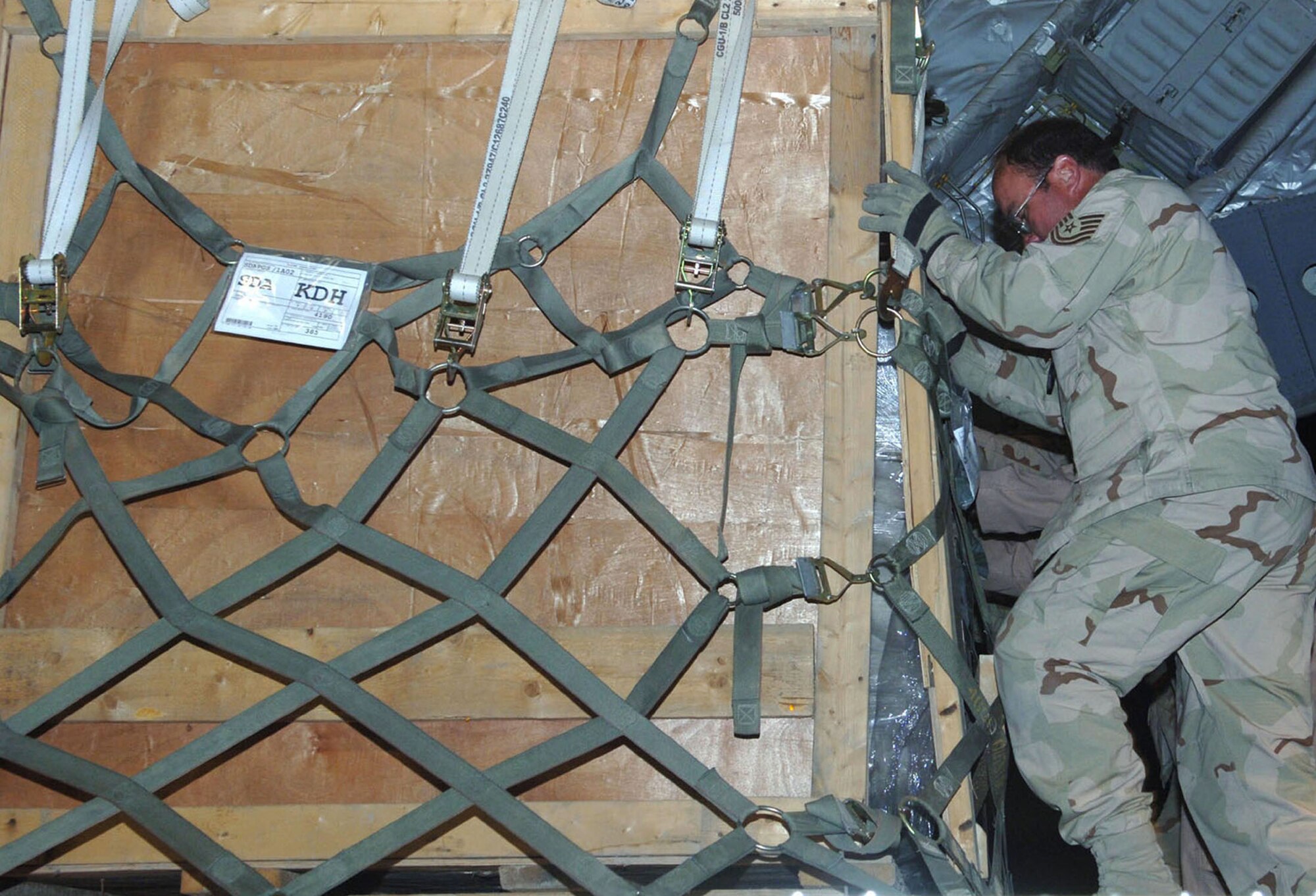 Tech. Sgt. Edward Johnston, of the 455th Expeditionary Logistics Readiness Squadron, helps push a pallet from a K-loader into the back of a C-17. (U.S. Air Force photo/Staff Sgt. Kevin Tomko)
